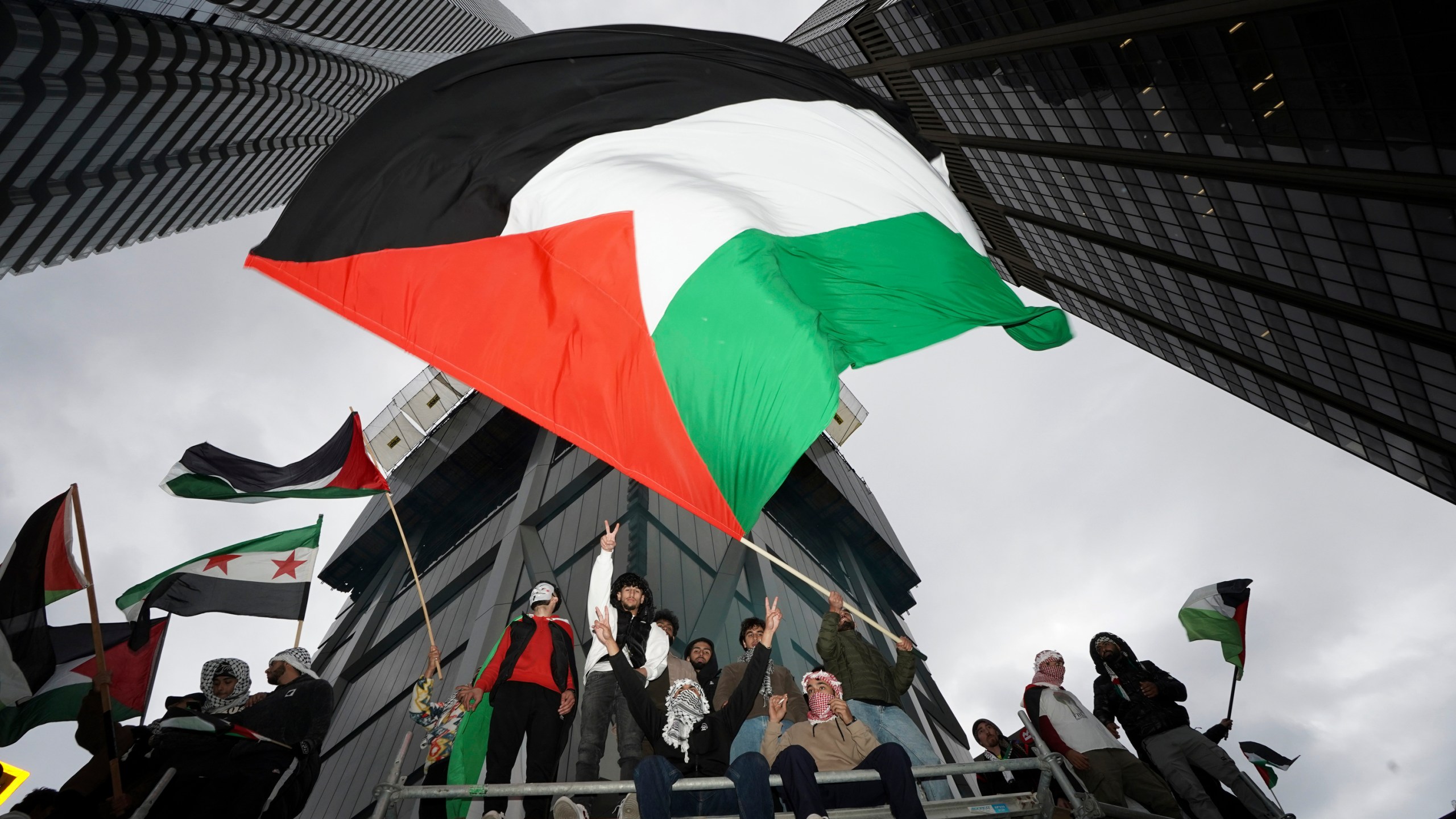 File - Supporters wave the Palestine flag at a march in Toronto, on Oct. 9, 2023. Before it transformed into X, Twitter was the place to turn to for live and reliable information about big news events, from wars to natural disasters. But as the Israel-Hamas war has underscored, that is no longer the case. (Arlyn McAdorey/The Canadian Press via AP, File)