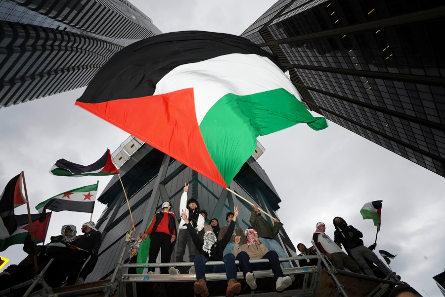 File - Supporters wave the Palestine flag at a march in Toronto, on Oct. 9, 2023. Before it transformed into X, Twitter was the place to turn to for live and reliable information about big news events, from wars to natural disasters. But as the Israel-Hamas war has underscored, that is no longer the case. (Arlyn McAdorey/The Canadian Press via AP, File)