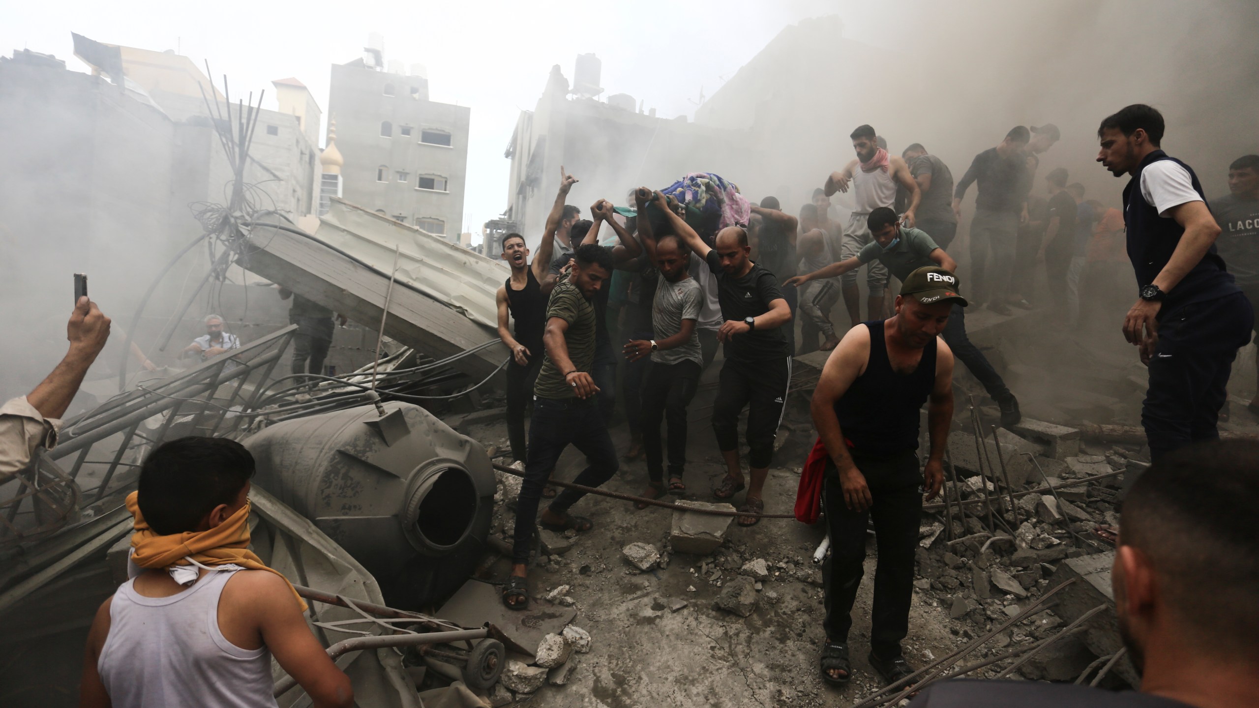 FILE - Palestinians remove a dead body from the rubble of a building after an Israeli airstrike Jebaliya refugee camp, Gaza Strip, Monday, Oct. 9, 2023. As Israeli warplanes pummel Gaza to avenge the Hamas attack, Palestinians say the military has largely unleashed its fury on civilians. (AP Photo/Ramez Mahmoud, File)