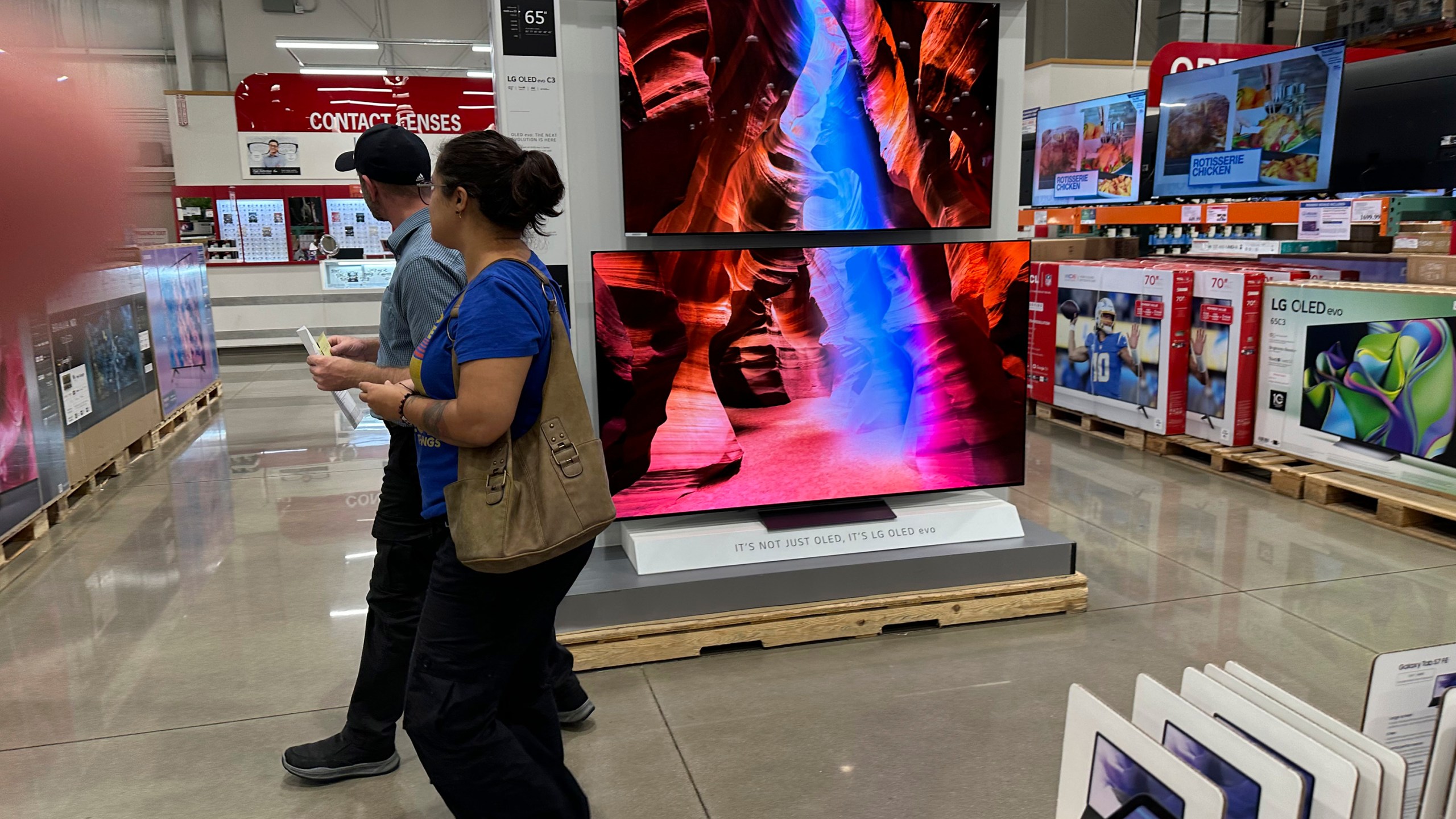 Shoppers pass by a display of big-screen televisions in a Costco warehouse Wednesday, Sept. 13, 2023, in Sheridan, Colo. On Thursday, the Labor Department issues its report on inflation at the consumer level.(AP Photo/David Zalubowski)