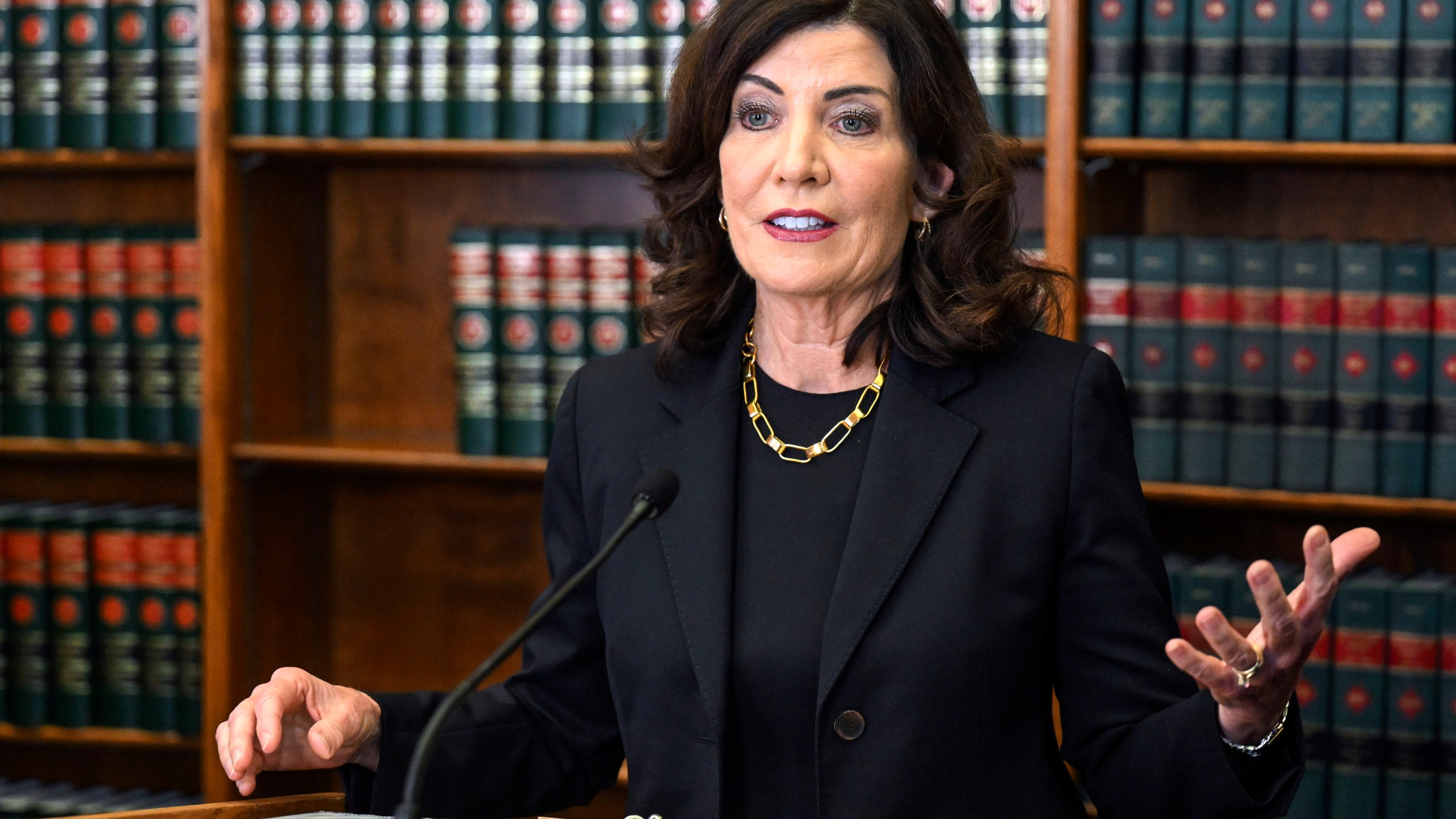 FILE - New York Gov. Kathy Hochul speaks to reporters, June 7, 2023, in Albany, N.Y. Hochul is supporting New York City's effort to suspend a unique legal agreement that requires it to provide emergency housing to homeless people, as a large influx of migrants overwhelms the city's shelter system. She endorsed the city's challenge to the requirement in a court filing on Wednesday, Oct. 11, telling reporters Thursday, Oct. 12, that the mandate was never meant to apply to an international humanitarian crisis. (AP Photo/Hans Pennink, File)