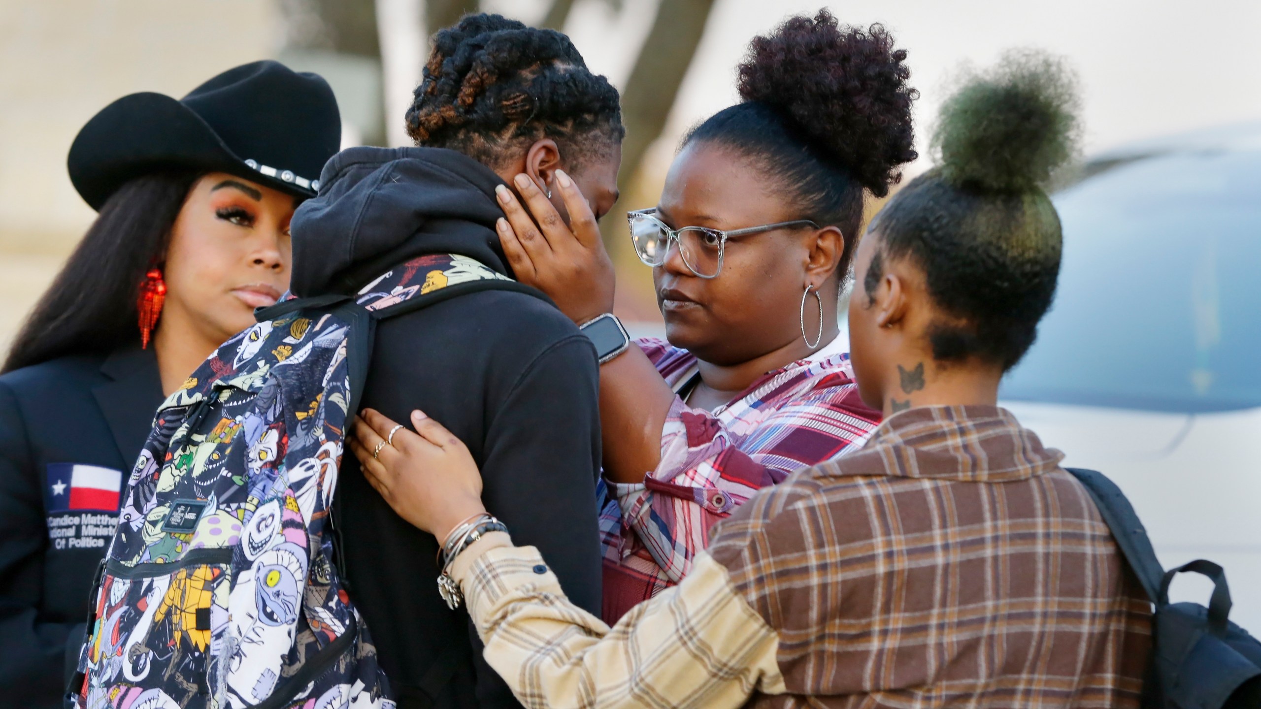 FILE - Darryl George, center left, a 17-year-old junior, and his mother Darresha George, center right, share words of encouragement before walking across the street to go into Barbers Hill High School after Darryl served a 5-day in-school suspension for not cutting his hair Monday, Sept. 18, 2023, in Mont Belvieu. George began attending a disciplinary program this week away from his classmates and regular teachers. He said in an interview with The Associated Press that he has felt isolated from and discouraged about not being able to play football or be more involved in campus events.(AP Photo/Michael Wyke, File)