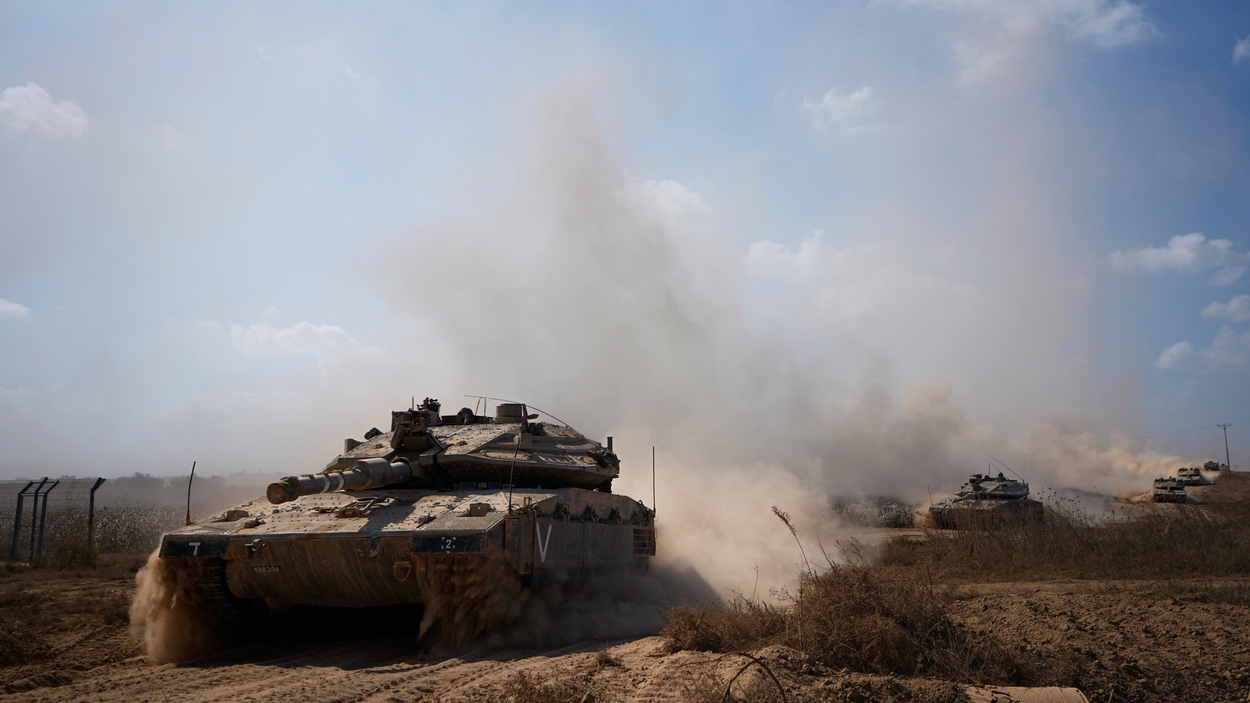 Israeli tanks head towards the Gaza Strip border in southern Israel on Friday, Oct.13, 2023. (AP Photo/Ariel Schalit)