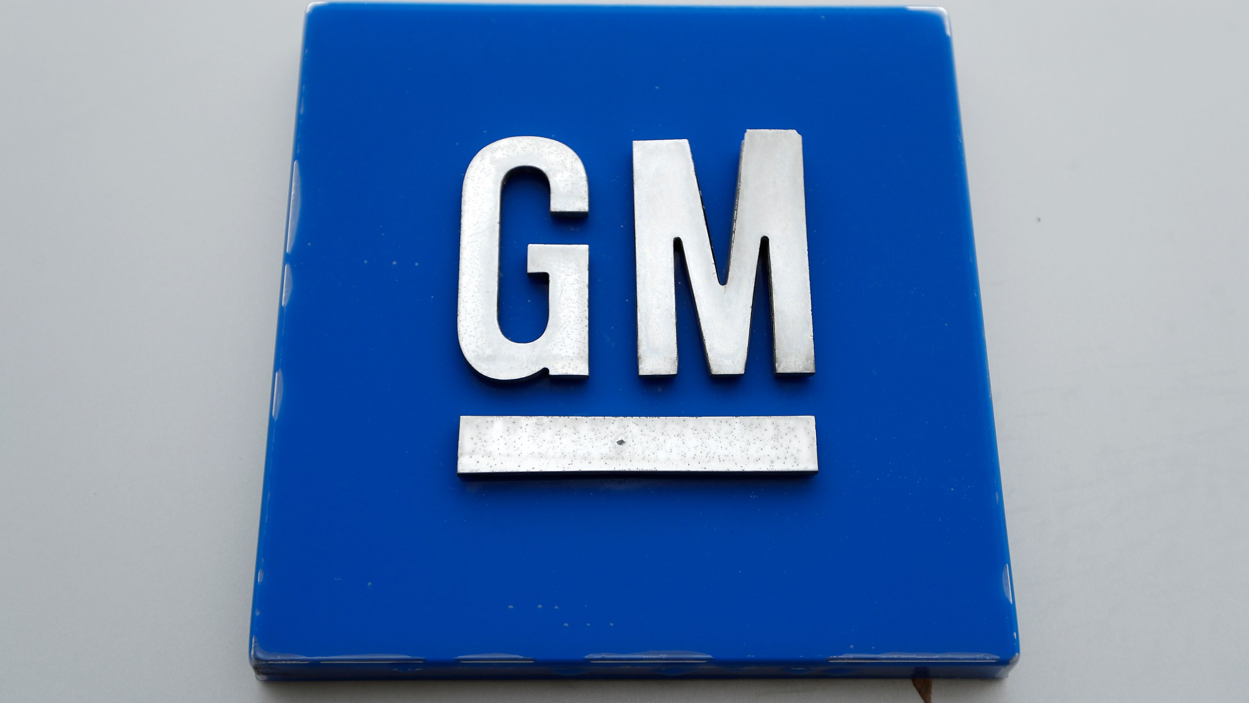 FILE - The General Motors logo is seen, Jan. 27, 2020, in Hamtramck, Mich. On Tuesday, Oct. 17, 2023, General Motors announced that it will delay electric pickup truck production at a factory near Detroit due to slowing U.S. demand for electric vehicles, to better manage its capital investments, and to make some engineering changes. (AP Photo/Paul Sancya, File)