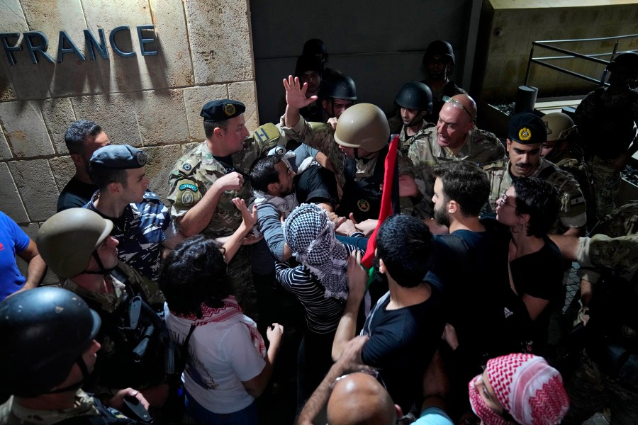 Demonstrators clash with the Lebanese army and riot police as they try to enter the French embassy during a protest in solidarity with the Palestinian people in Gaza, in Beirut, Lebanon, Tuesday, Oct. 17, 2023. Groups of protesters roamed the city on motorcycles and gathered outside the French embassy, and the headquarters of the U.N. Economic and Social Commission for Western Asia. They were unable to reach the heavily fortified U.S. embassy compound in the hills north of Beirut. (AP Photo/Bilal Hussein)