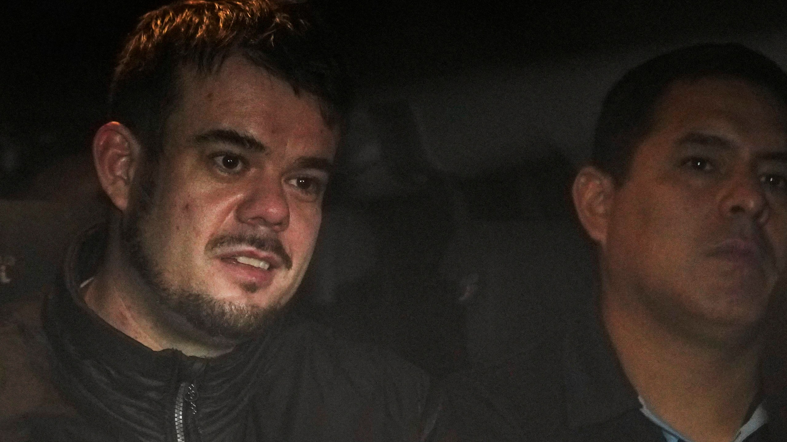 FILE - Dutch citizen Joran van der Sloot, left, is driven in a police vehicle from a maximum-security prison to an airport to be extradited to the U.S., on the outskirts of Lima, Peru, Thursday, June 8, 2023. Court records filed Friday, Oct. 13, indicate Van der Sloot, the chief suspect in Natalee Holloway’s 2005 disappearance, intends to plead guilty in a federal case accusing him of trying to extort money from the missing teen’s mother. (AP Photo/Martin Mejia, File)