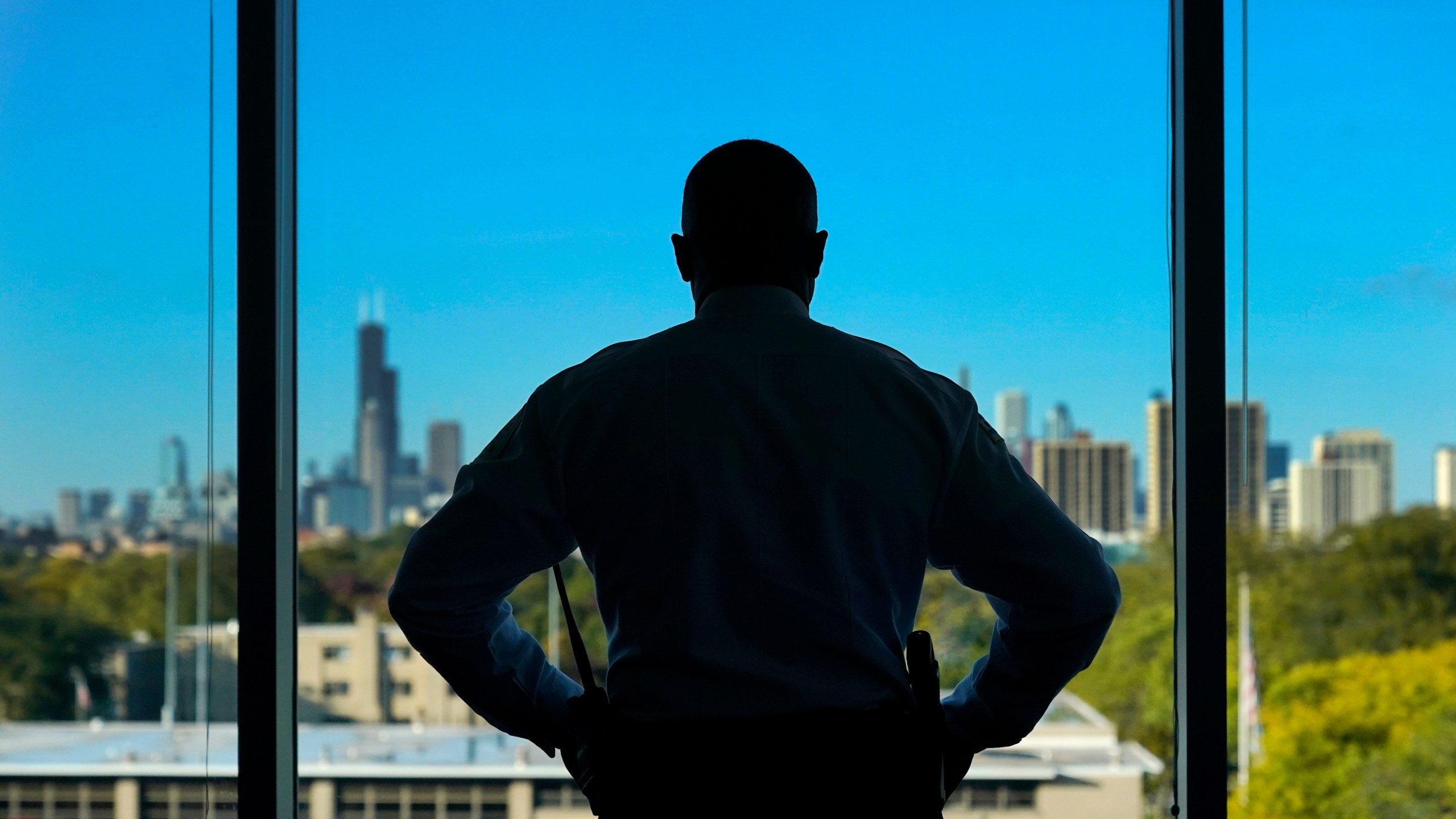 Chicago Police Superintendent Larry Snelling stands for a portrait at his office over looking the city's skyline after an interview with The Associated Press Tuesday, Oct. 17, 2023, in Chicago. Snelling says the city’s use of police stations as temporary housing for the growing population of migrants seeking asylum has been a "burden" on the nation’s second-largest police department. More than 18,500 migrants have arrived in Chicago since last year. (AP Photo/Charles Rex Arbogast)