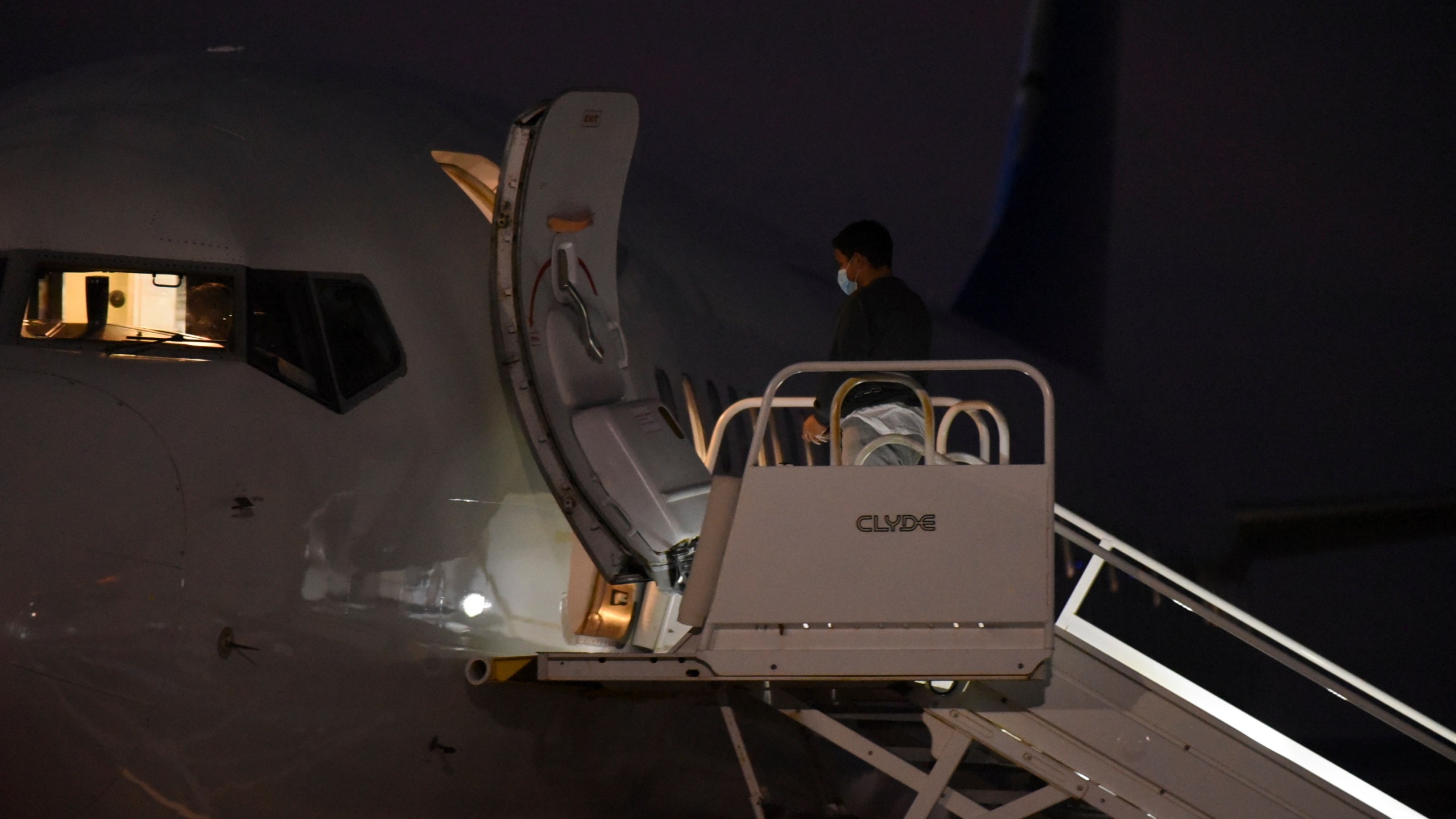 Venezuelan migrants board a plane heading back to their home country from Harlingen, Texas, on Wednesday, Oct. 18, 2023. U.S. immigration officials say passengers chosen for the deportation flight included recent arrivals as well as migrants who have committed crimes in the U.S. (AP Photo/Valerie Gonzalez)