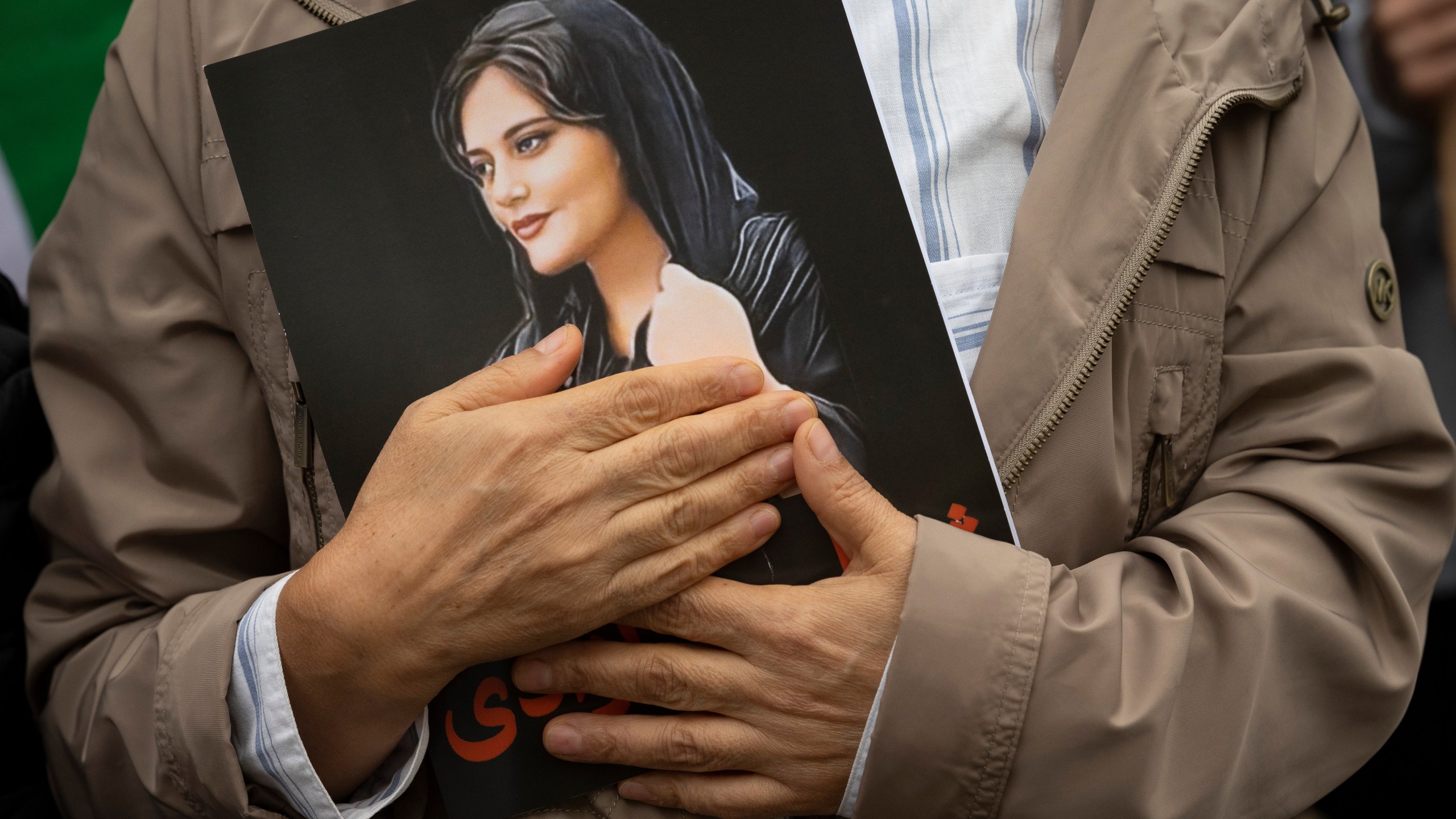 FILE - A portrait of Mahsa Amini is held during a rally calling for regime change in Iran following the death of Amini, a young woman who died after being arrested in Tehran by Iran's notorious "morality police," in Washington, on Oct. 1, 2022. Mahsa Amini, the 22-year-old Kurdish-Iranian woman who died in police custody in Iran last year, sparking worldwide protests against the country’s conservative Islamic theocracy, was awarded the European Union’s top human rights prize on Thursday, Oct. 19, 2023. (AP Photo/Cliff Owen, File)