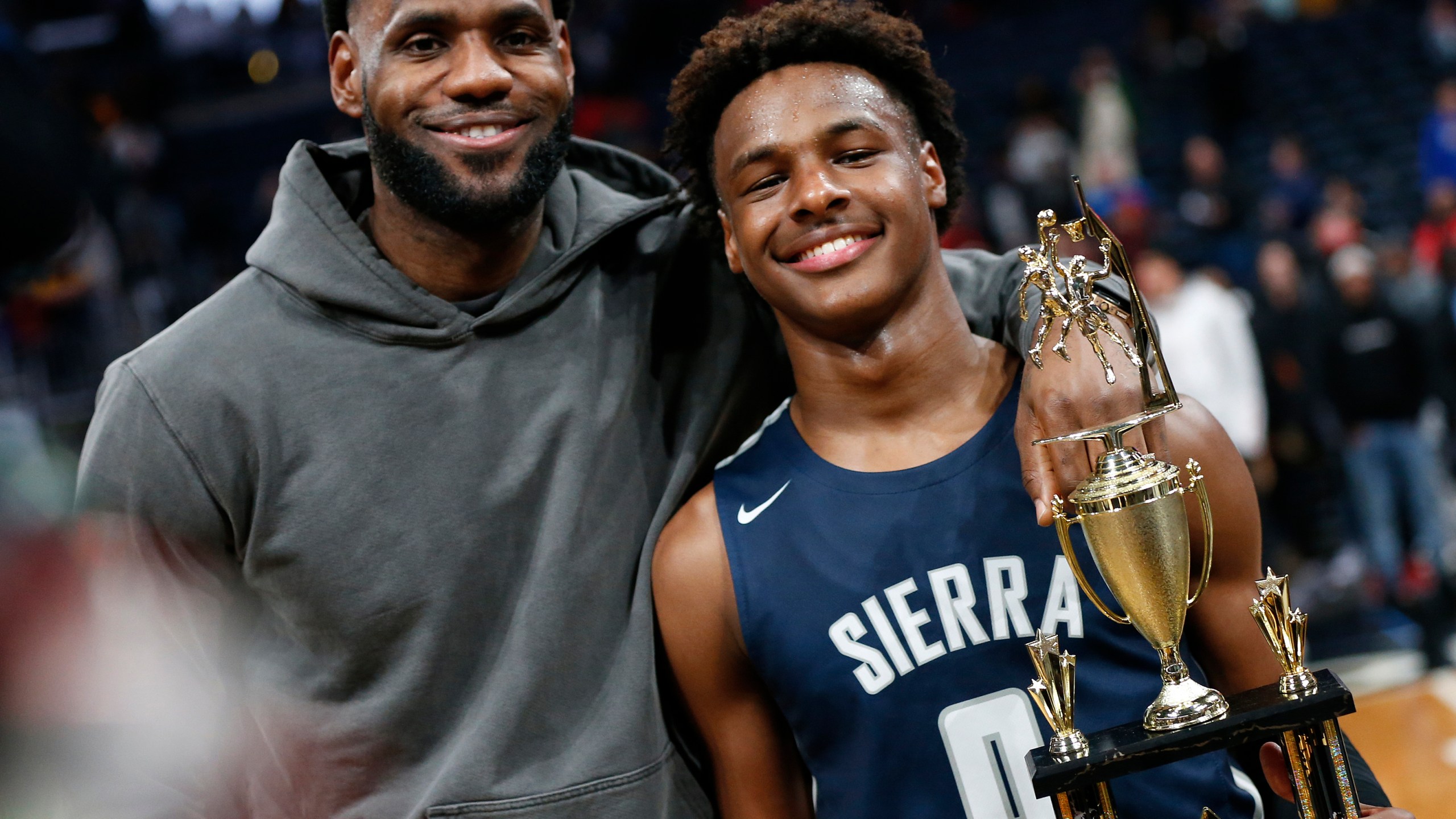 FILE - Los Angeles Lakers forward LeBron James, left, poses with his son Bronny after Sierra Canyon defeated Akron St. Vincent-St. Mary in a high school basketball game Dec. 14, 2019, in Columbus, Ohio. Bronny James joined his Southern California teammates in a preseason fan event at Galen Center, Thursday, Oct. 19, 2023. (AP Photo/Jay LaPrete, File)