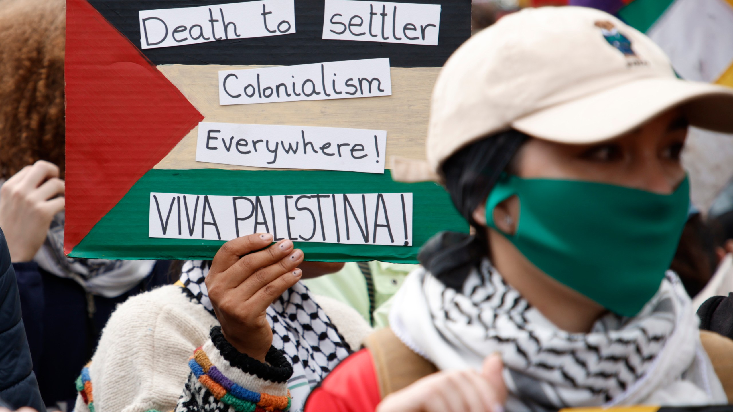 Demonstrators hold up flags and placards during a pro Palestinian demonstration in London, Saturday, Oct. 21, 2023. (AP Photo/David Cliff)