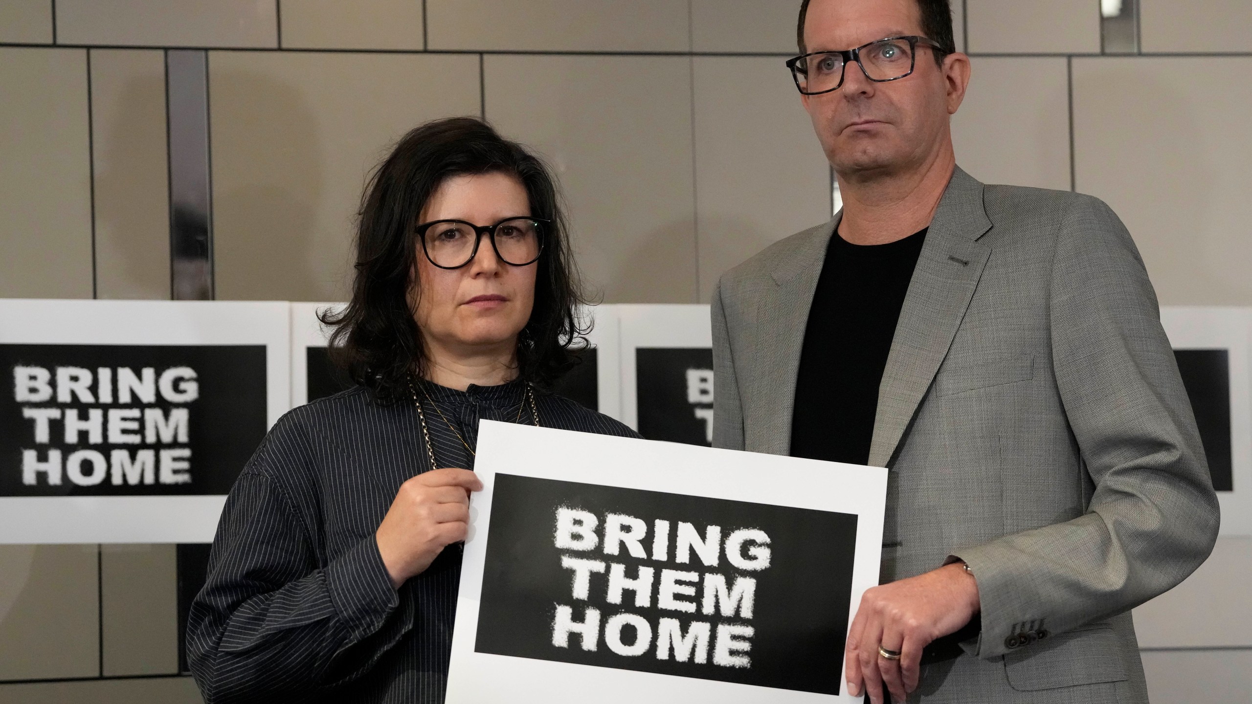 Sharon Lifschitz, left, and Noam Sagi pose for photographers after a press conference of British children of Israeli hostages at a hotel in London, Thursday, Oct. 12, 2023. Noam Sagi, 53, is a London-based psychotherapist who grew up on Kibbutz Nir Oz. His 75-year-old mother, Ada Sagi, was taken hostage on October 7. Sharon Lifschitz, 52, is an artist and academic whose parents are peace activists aged 85 and 83 and were taken hostage too.(AP Photo/Kirsty Wigglesworth)