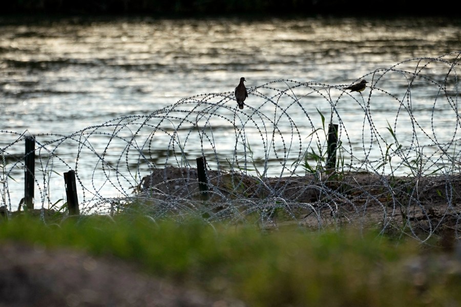 FILE - Birds rest on concertina wire along the Rio Grande in Eagle Pass,Texas, July 6, 2023. Texas sued the Biden administration Tuesday, Oct. 24, seeking to stop federal agents from cutting the state's razor wire that has gashed or snagged migrants as they have attempted to enter the U.S. from Mexico at the Rio Grande. (AP Photo/Eric Gay, File)