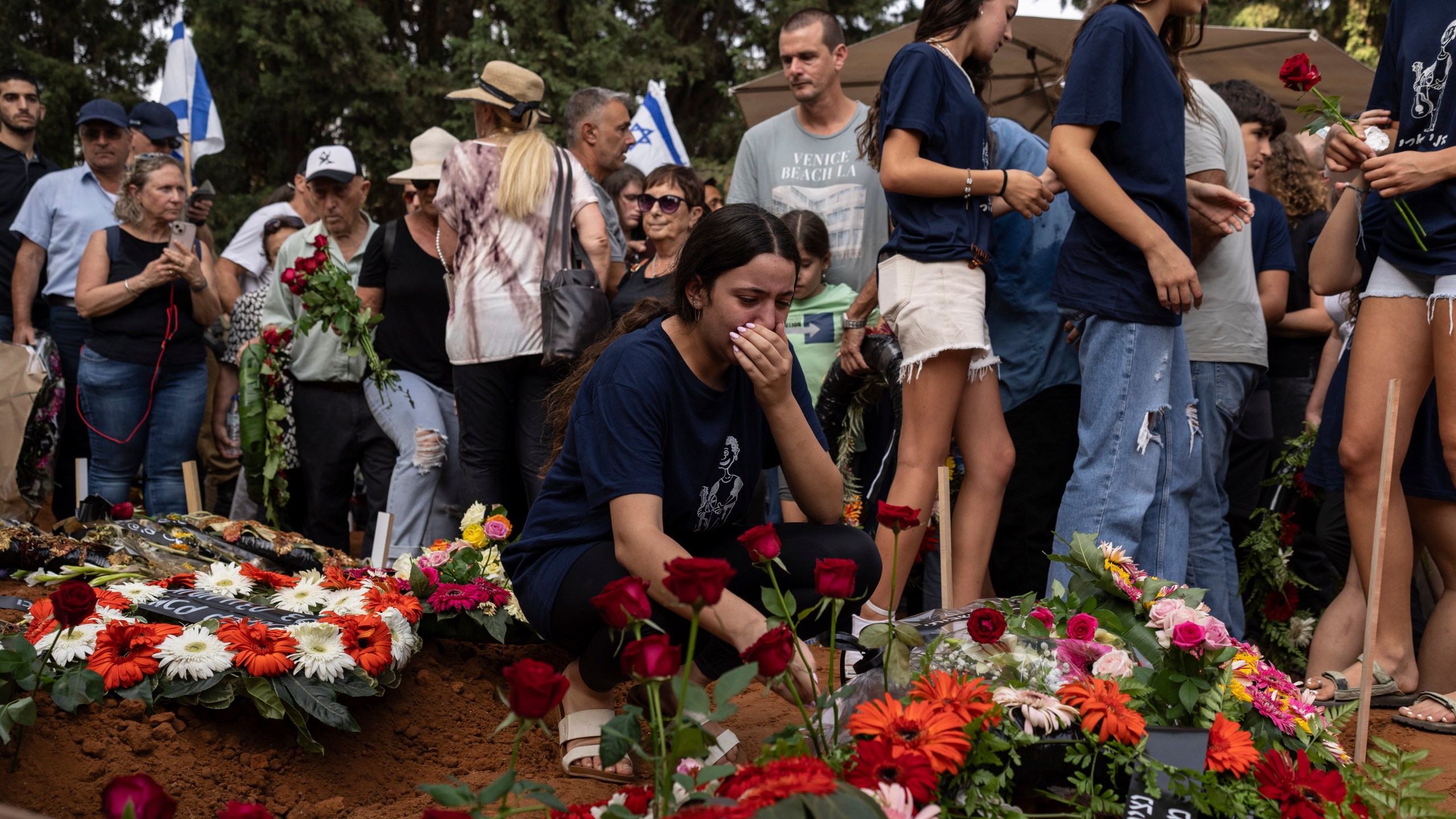 Mourners attend the funeral of Dana Bachar and her son Carmel , at Gan Shlomo cemetery, central Israel, Tuesday, Oct. 24, 2023. Carmel Bachar, 15-year-old and his mother Dana lived in kibbutz Be'eri, a small community with a little more than 1,000 people, that was one of more than 20 towns and villages ambushed on Oct. 7 as part of a surprise attack by Hamas militants against Israel where dozens were killed.(AP Photo/Petros Giannakouris)