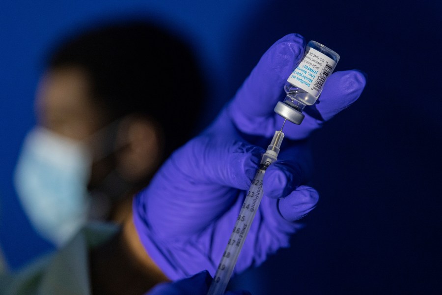 FILE - A family nurse practitioner prepares a syringe with the Mpox vaccine for inoculating a patient at a vaccination site in the Brooklyn borough of New York, on Tuesday, Aug. 30, 2022. Gay and bisexual men at high risk for mpox infection should get vaccinated for the virus even after the current outbreak ends, government health advisers said Wednesday, Oct. 25, 2023. (AP Photo/Jeenah Moon, File)