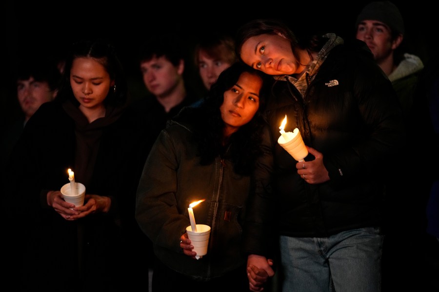 People gather at a vigil for the victims of Wednesday's mass shootings, Sunday, Oct. 29, 2023, outside the Basilica of Saints Peter and Paul in Lewiston, Maine. (AP Photo/Matt Rourke)