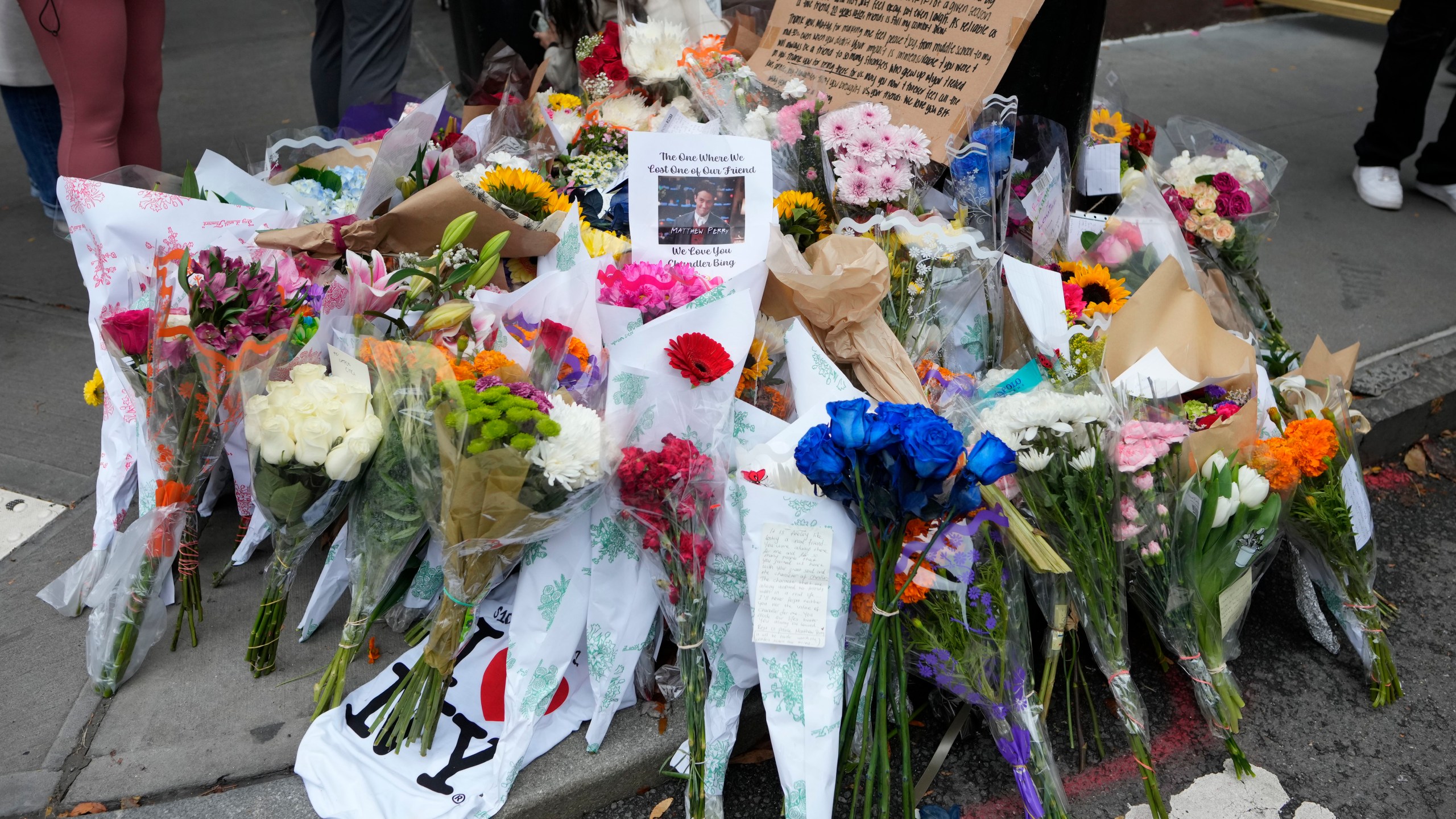 A makeshift memorial for Matthew Perry is seen outside the building shown in exterior shots of the television show "Friends" on Monday, Oct. 30, 2023, in New York. Perry, who played Chandler Bing on NBC's "Friends" for 10 seasons, was found dead at his Los Angeles home on Saturday. He was 54. (Photo by Charles Sykes/Invision/AP)