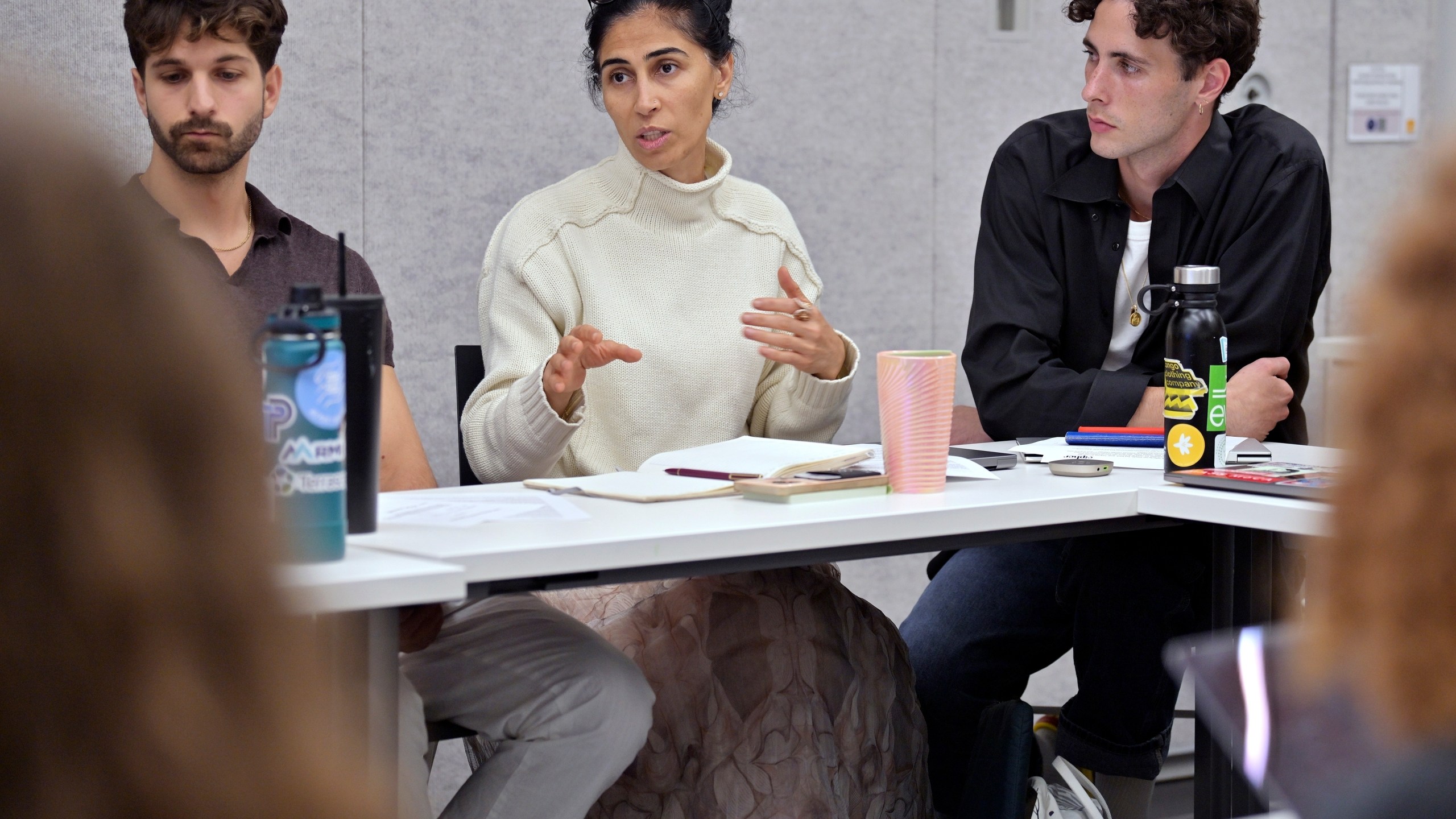 Leyla Uysal, a design school student from Harvard University with an urban planning background, center, speaks during a course concerning the conflicts that arise in the siting process of renewable energy projects, at the Massachusetts Institute of Technology, Friday, Sept. 15, 2023, in Cambridge, Mass. Mike Giovanniello, left, and Kailin Graham listen to the discussion. "It's going to be difficult, but I will educate myself not to take sides," Uysal said. (AP Photo/Josh Reynolds)