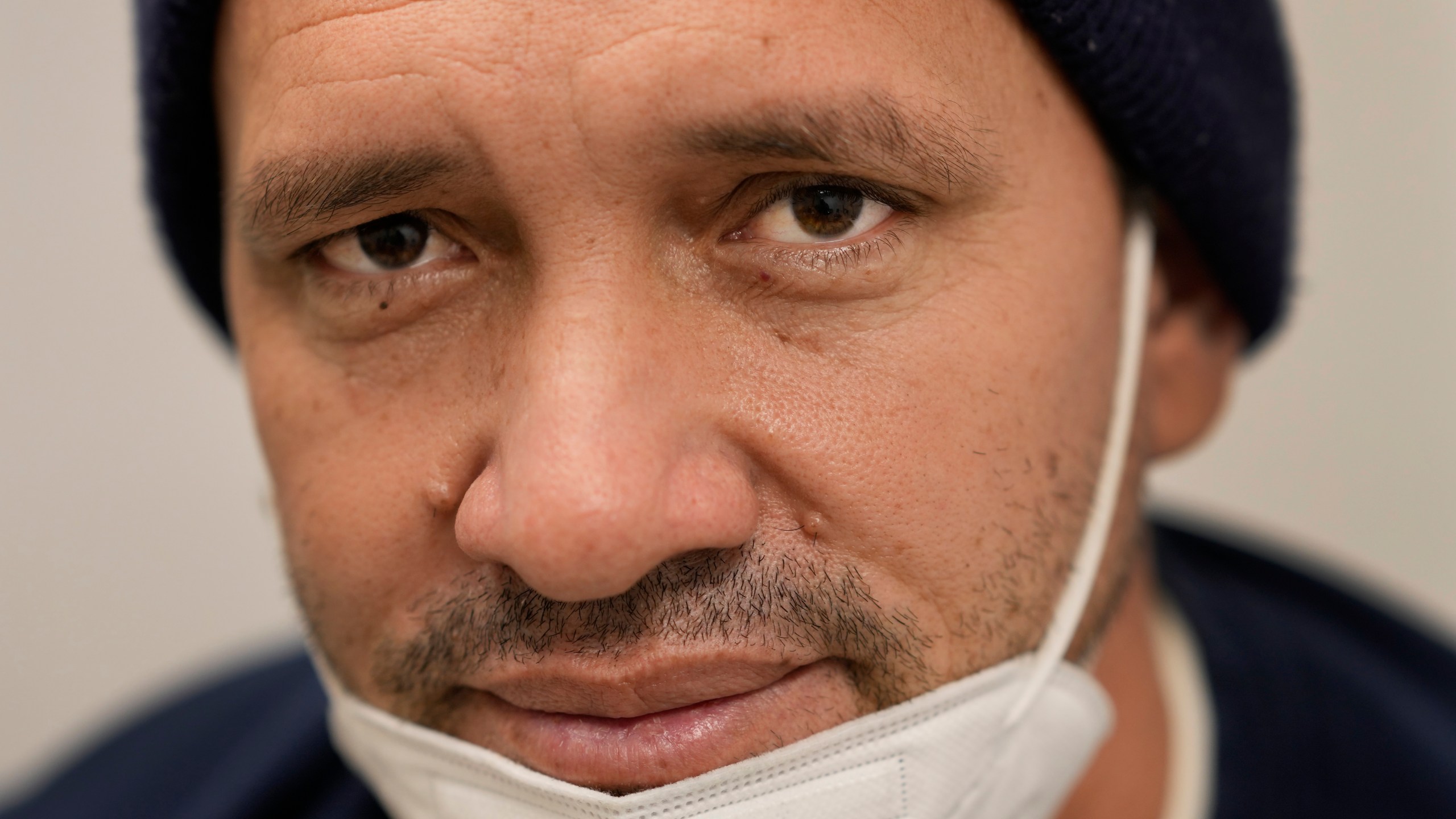 Julio Figuera, 43, sits for a portrait while he waits for medical treatment at the Cook County, Ill., medical clinic on Monday, Oct. 16, 2023, in Chicago. "I rarely get sick," he said. "It was the journey that got me sick." Figuera, developed pneumonia since arriving in the U.S. and has been living with hundreds of other asylum seekers at the airport while awaiting more city permanent shelter. When migrants began arriving in Chicago last year, city leaders tapped the county's health system to take over medical care. (AP Photo/Charles Rex Arbogast)