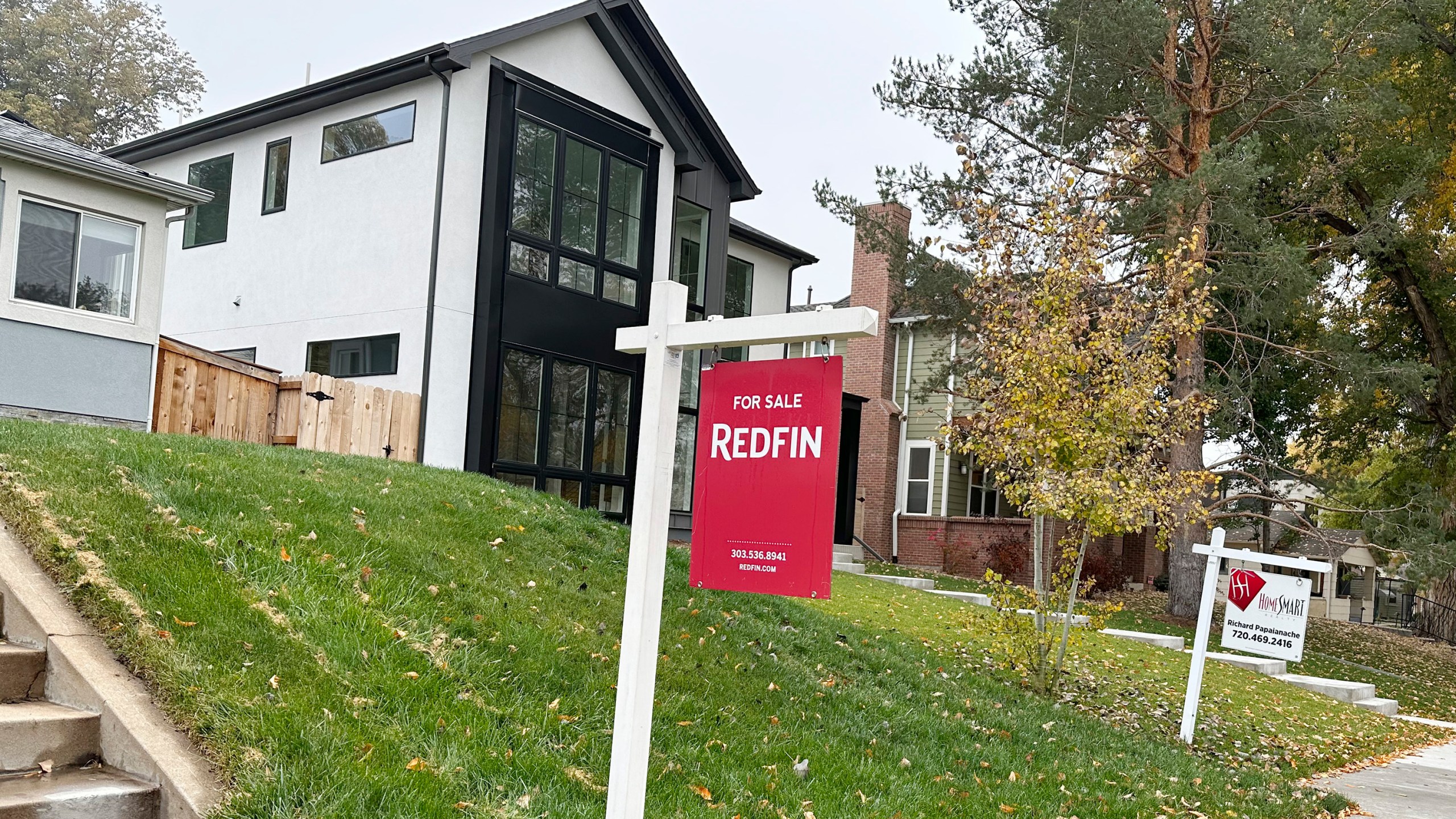 Signs stand in front of homes for sale along South St. Paul Street Thursday, Oct. 26, 2023, in southeast Denver. On Thursday, Freddie Mac reports on this week's average U.S. mortgage rates. (AP Photo/David Zalubowski)