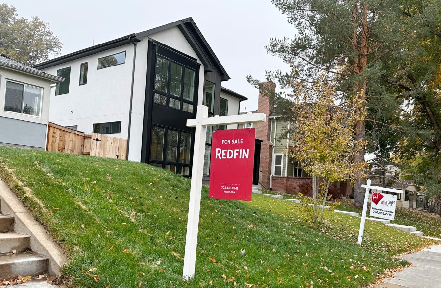 Signs stand in front of homes for sale along South St. Paul Street Thursday, Oct. 26, 2023, in southeast Denver. On Thursday, Freddie Mac reports on this week's average U.S. mortgage rates. (AP Photo/David Zalubowski)