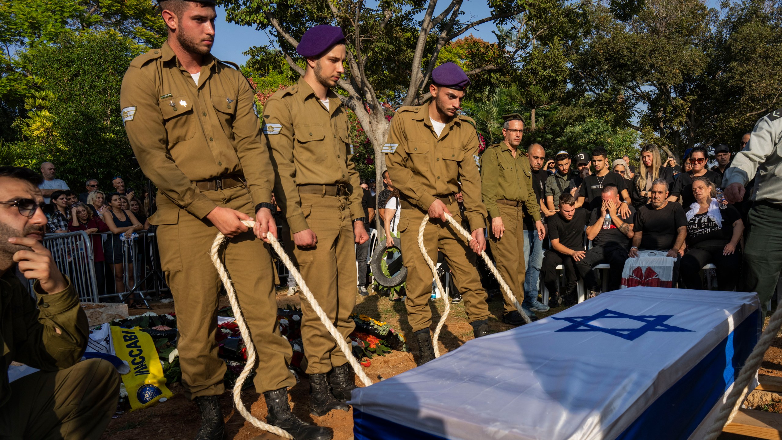 Israeli soldiers lower the coffin of late Israeli Staff Sergeant Shay Arvas at the Holon military cemetery, outskirts of Tel Aviv, Israel, Thursday, Nov. 2, 2023. Sergeant Arvas, 20, was killed on Oct 31, during IDF's ground operation in Gaza Strip. (AP Photo/Bernat Armangue)