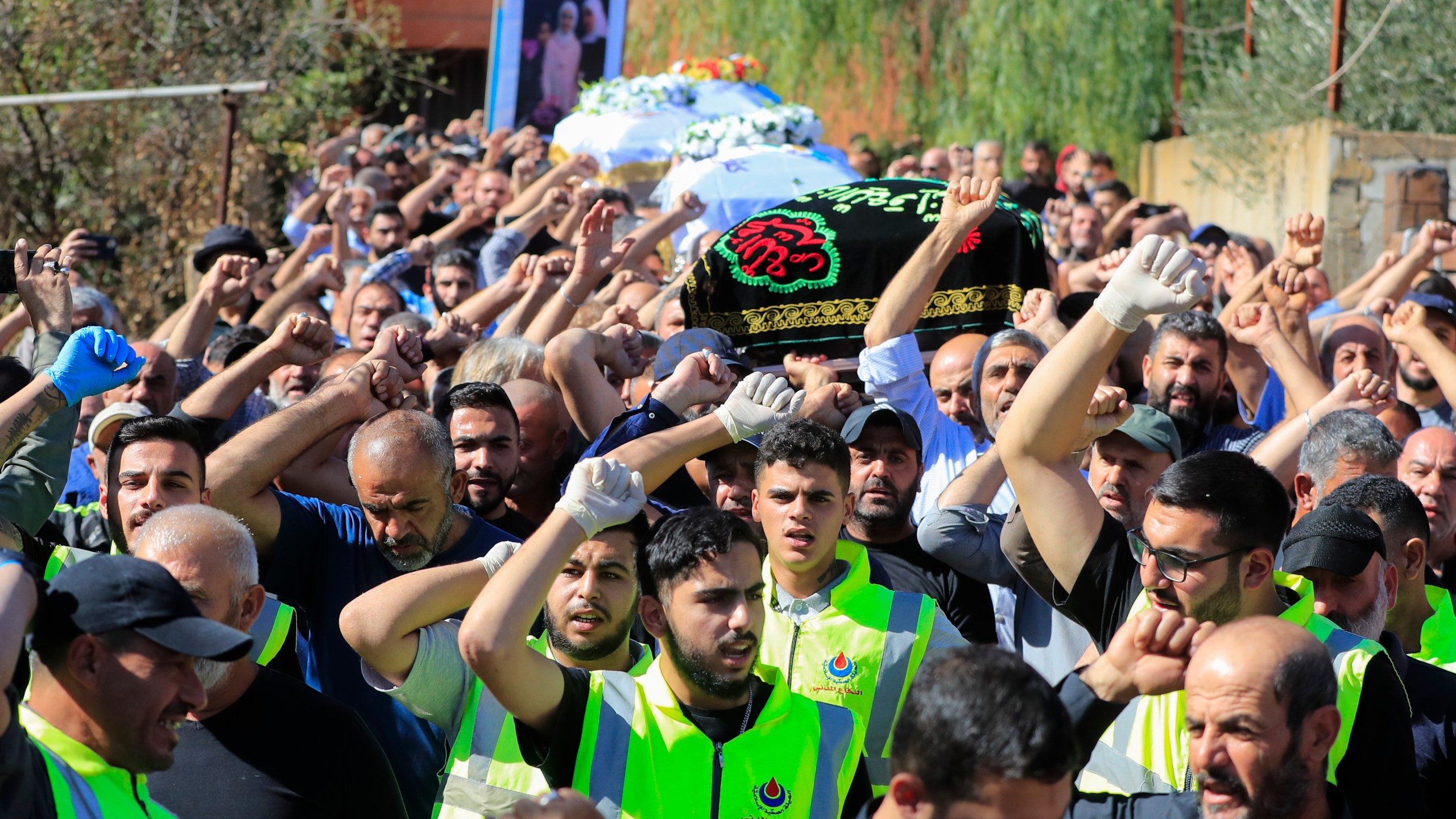 People carry the coffins of the victims who were killed by an Israeli airstrike, chant slogans during their funeral procession in the town of Blida, a Lebanese border village with Israel in south Lebanon, Tuesday, Nov. 7, 2023. A Lebanese woman and her three grand daughters were laid to rest in their hometown in southern Lebanon two days after they were killed in an Israeli drone strike while in a car near the Lebanon-Israel border. (AP Photo/Mohammed Zaatari)