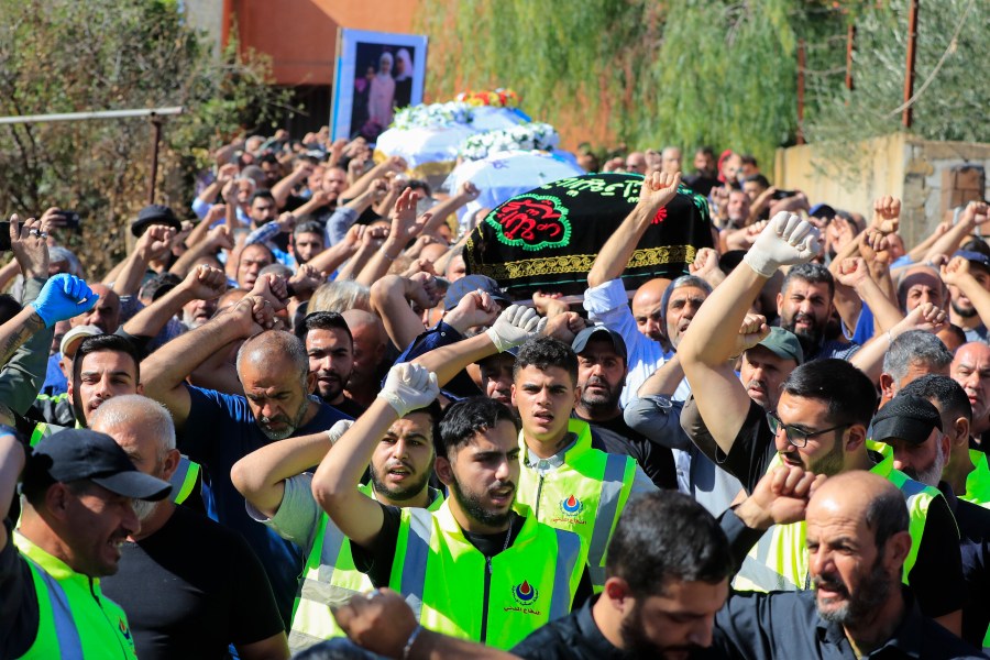 People carry the coffins of the victims who were killed by an Israeli airstrike, chant slogans during their funeral procession in the town of Blida, a Lebanese border village with Israel in south Lebanon, Tuesday, Nov. 7, 2023. A Lebanese woman and her three grand daughters were laid to rest in their hometown in southern Lebanon two days after they were killed in an Israeli drone strike while in a car near the Lebanon-Israel border. (AP Photo/Mohammed Zaatari)