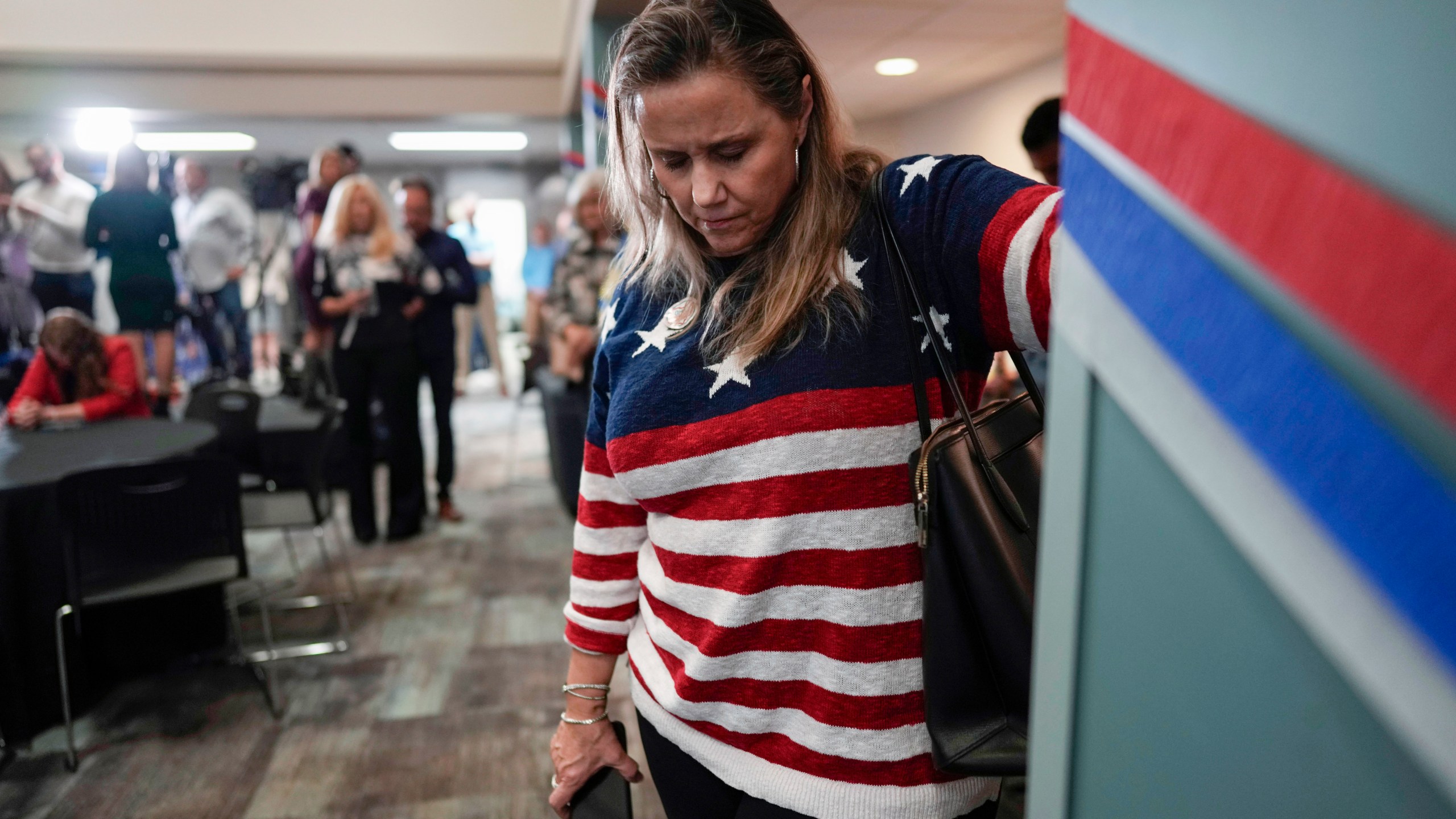 A woman bows her head during a prayer at a watch party for opponents of Issue 1 at the Center for Christian Virtue in Columbus, Ohio, Tuesday, Nov. 7, 2023. (AP Photo/Carolyn Kaster)