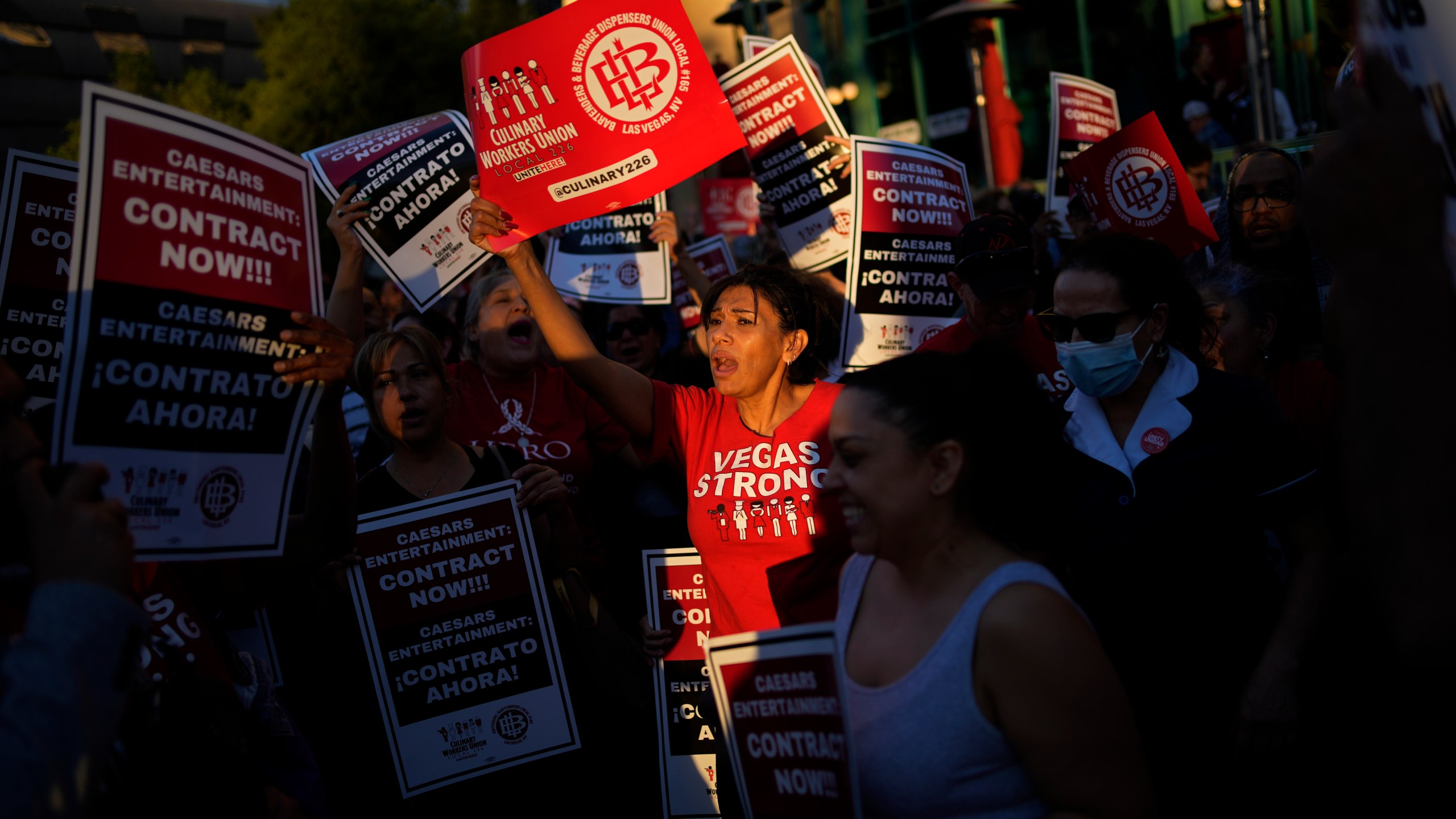 FILE - Members of the Culinary Workers Union rally along the Strip, Wednesday, Oct. 25, 2023, in Las Vegas. After a marathon week of negotiations, the Las Vegas hotel workers union says it has reached a tentative deal with Wynn Resorts. It was the last contract the Culinary Workers Union needed to avoid a strike Friday, Nov. 10, 2023, and came after the union's tentative deals with Caesars Entertainment and MGM Resorts. (AP Photo/John Locher, File)