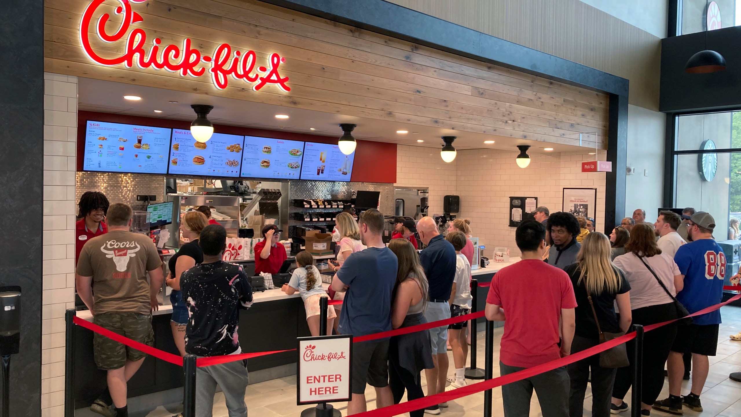 File - People line up to order fast food from a Chick-fil-A restaurant at the Iroquois Travel Plaza rest stop on the New York State Thruway in Little Falls, New York, on June 30, 2023. On Tuesday, the Labor Department issues its report on inflation at the consumer level in October. (AP Photo/Ted Shaffrey, File)