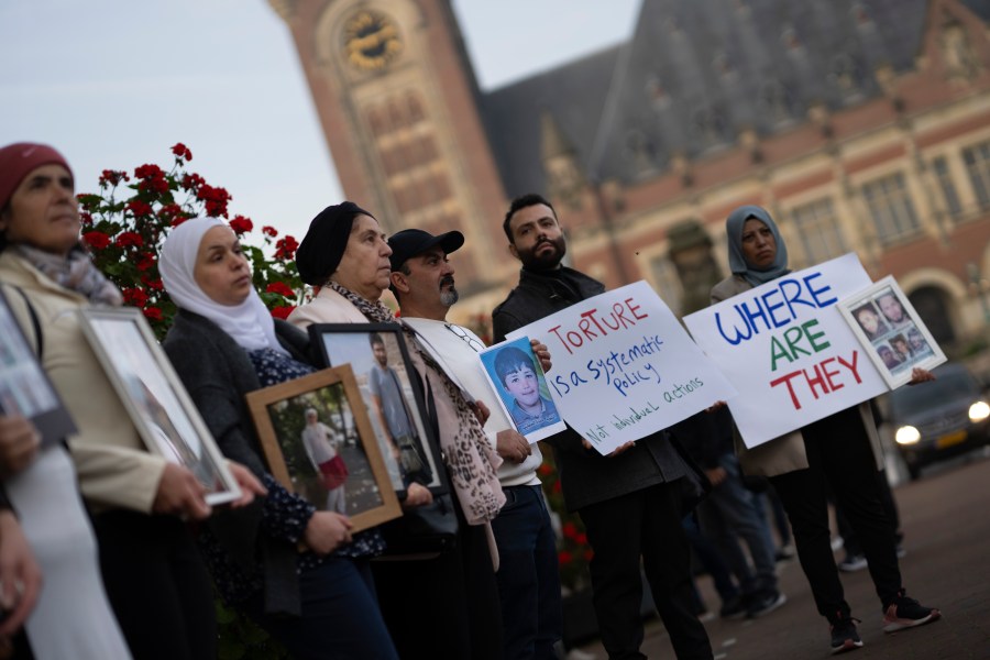 FILE - Demonstrators display pictures of people, they say disappeared in Syria, outside the International Court of Justice, or World Court, in The Hague, Netherlands, Tuesday, Oct. 10, 2023. The United Nations' top court on Thursday ordered the Syrian government to “take all measures within its powers” to prevent torture, in a case in which the Netherlands and Canada accuse Damascus of a years-long campaign of torturing its own citizens. (AP Photo/Peter Dejong, File)