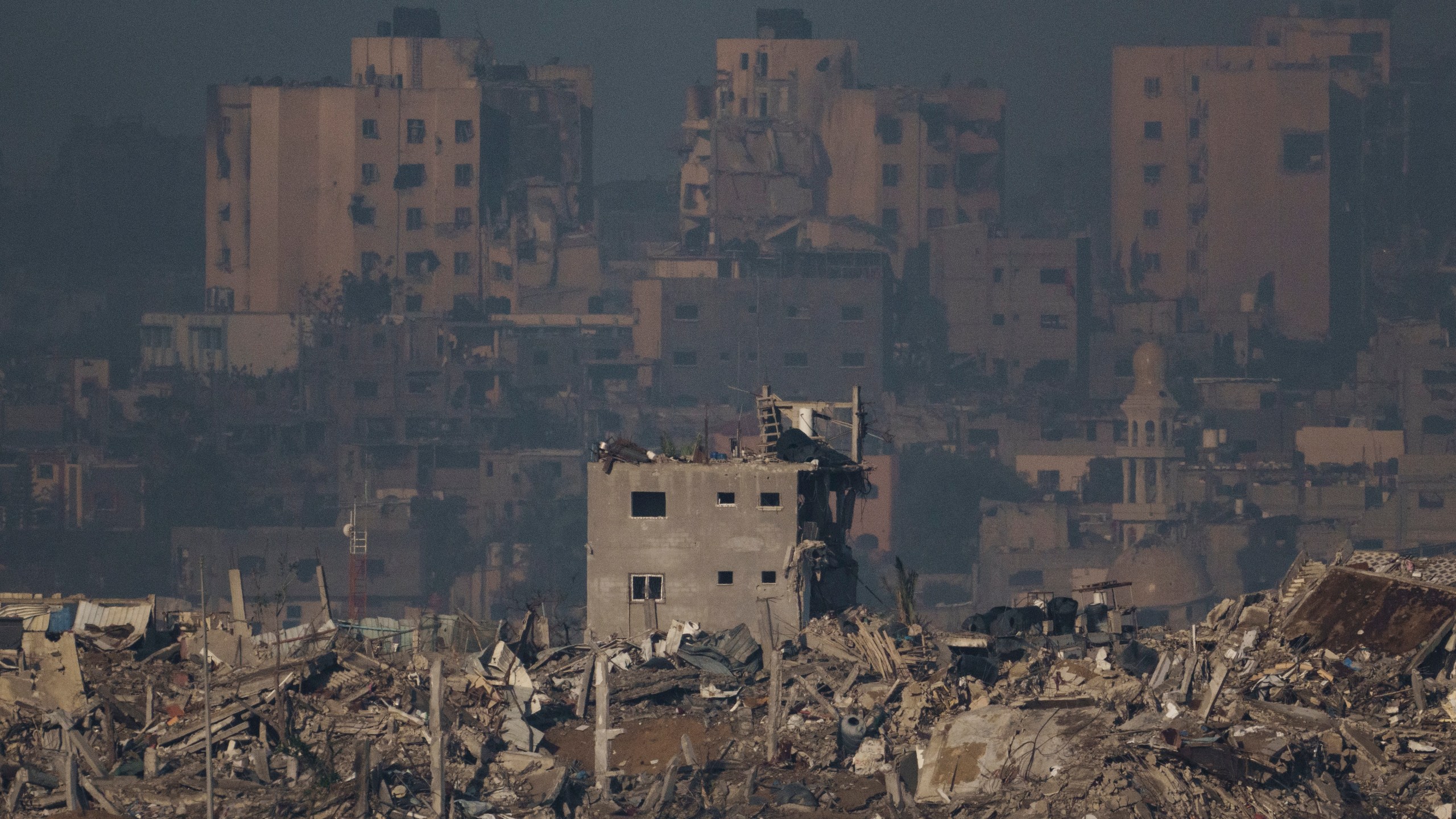 Destroyed buildings are seen in the Gaza Strip, as seen from southern Israel, Monday, Nov. 20, 2023. (AP Photo/Leo Correa)