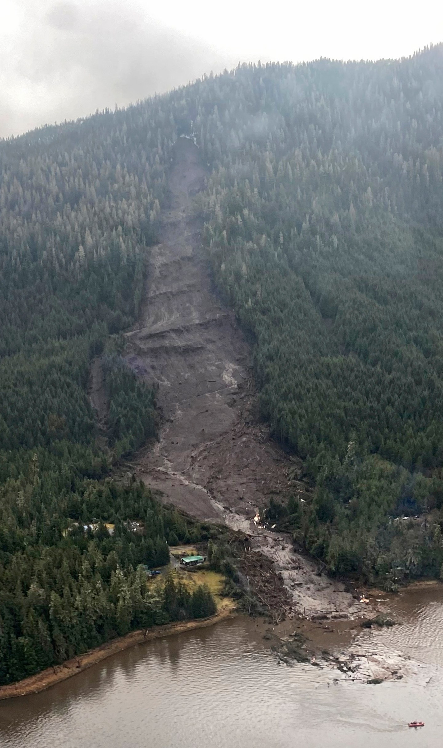 This photo provided by Sunrise Aviation shows the landslide that occurred the previous evening near Wrangell, Alaska, on Nov. 21, 2023. Authorities said at least one person died and others were believed missing after the large landslide roared down a mountaintop into the path of three homes. (Sunrise Aviation via AP)