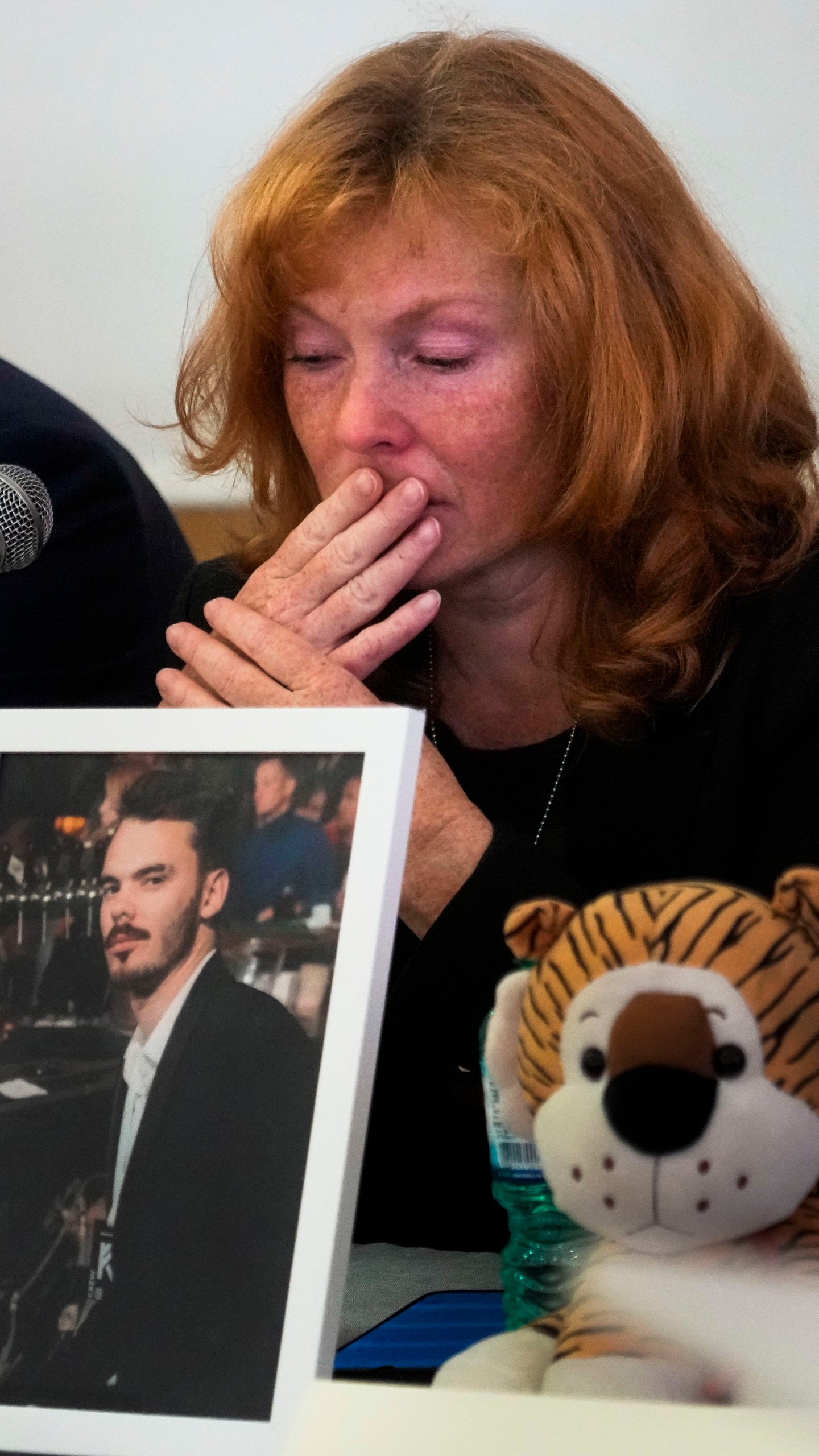 Evgenia Kozlov gets emotional during a press conference at the Italian Jewish Center in Rome, Wednesday, Nov. 22, 2023, with other representatives of the families of the Israelis abducted by Hamas militants on Oct. 7 and believed to be held hostages in Gaza, shortly after they met with Pope Francis at The Vatican. Her 27-year-old son Andrei, depicted in the framed photograph, a Russian citizen, was abducted by Hamas militants from the "Nova" Music Festival near Kibbutz Re'im during the militant group's unprecedented attack on Israel on Oct. 7 that resulted in the killing of 1,400 people and the abduction of over 220. (AP Photo/Gregorio Borgia)