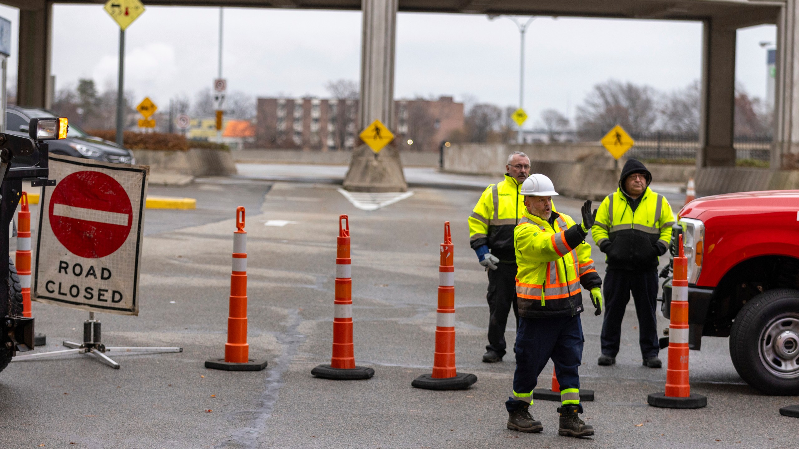 Workers block the entrance to the Rainbow Bridge border crossing between the U.S. and Canada, Wednesday, Nov. 22, 2023, in Niagara Falls, Ontario, after a vehicle exploded at a checkpoint on the American side of the bridge (Carlos Osorio/The Canadian Press via AP)