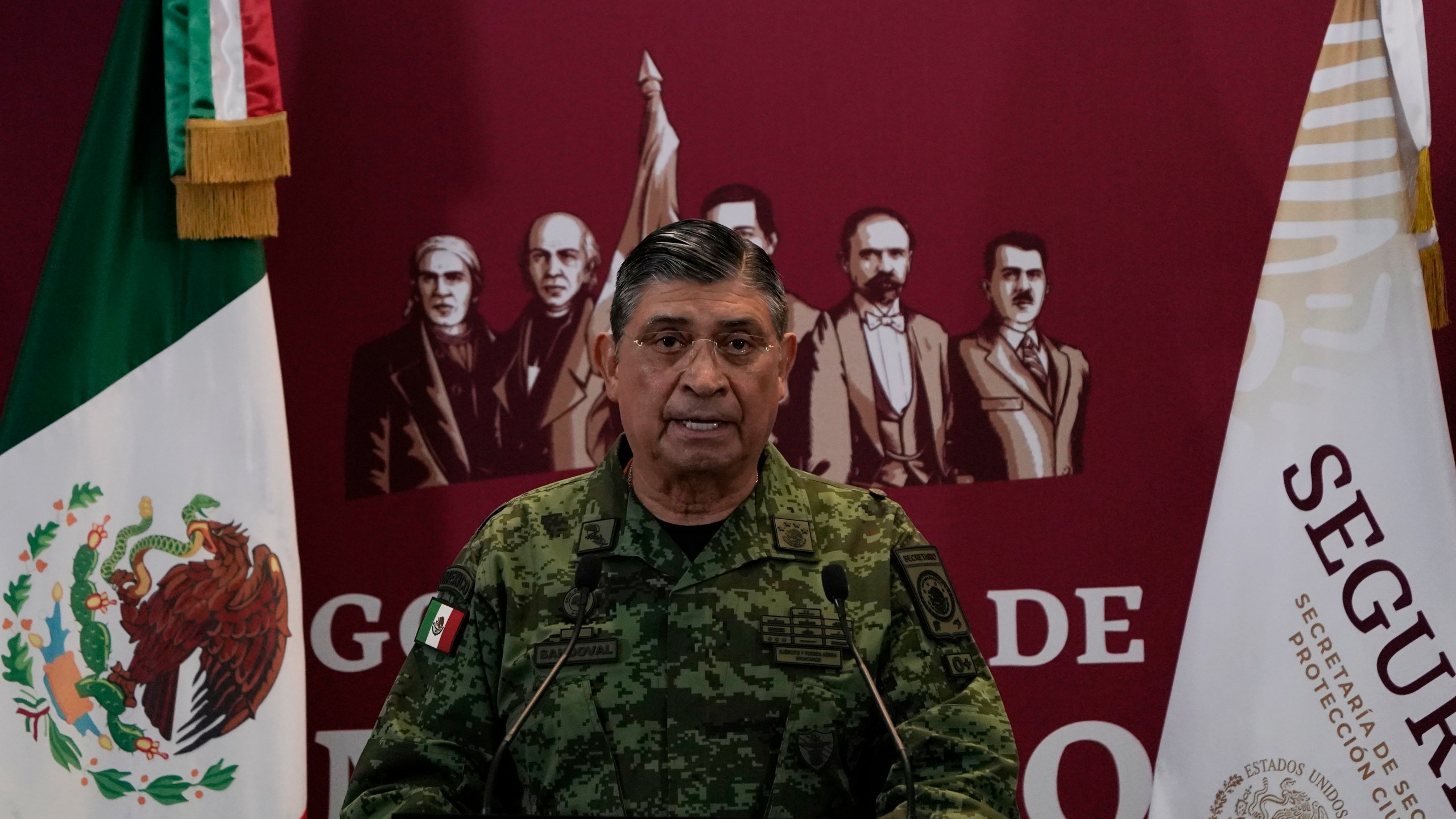 FILE - Mexican Defense Secretary Luis Cresencio Sandoval announces the arrest of Ovidio during a press conference in Mexico City, on Jan. 5, 2023. The U.S. government thanked Mexico for arresting a hyper violent alleged Sinaloa cartel security chief, but according to details released Friday, Nov. 24, 2023 the arrest of suspect Nestor Isidro Pérez Salas this week may have been highly personal for the Mexican army. Sandoval said Pérez Salas had ordered a 2019 attack on an unguarded apartment complex where soldiers’ families lived. (AP Photo/Eduardo Verdugo, File)