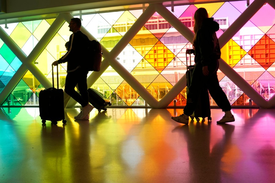 FILE - Travelers walk through Miami International Airport ahead of the Thanksgiving holiday, Wednesday, Nov. 22, 2023, in Miami. A record number of passengers traveled through U.S. airports over Thanksgiving weekend, the Transportation Security Administration said Monday, Nov. 27. (AP Photo/Lynne Sladky, File)