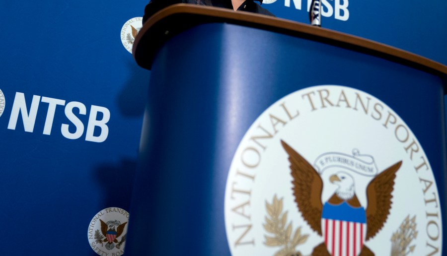 FILE - The National Transportation Safety Board logo and signage are seen at a news conference at NTSB headquarters in Washington, Dec. 18, 2017. The nation’s top accident investigator says a surge in close calls between planes at U.S. airports this year is a clear warning sign that aviation is under stress. Jennifer Homendy, chair of the National Transportation Safety Board, told a Senate panel Thursday, Nov. 8, 2023 that close calls are incredibly rare, but we cannot ignore the recent increase in such events. (AP Photo/Andrew Harnik, File)