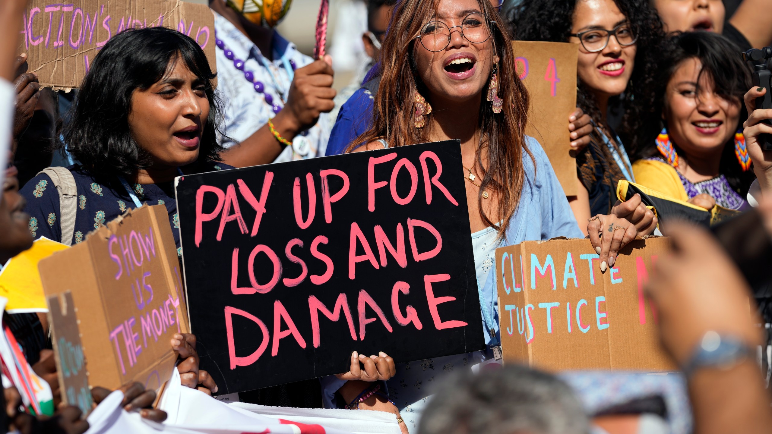 FILE - Mitzi Jonelle Tan, of the Philippines, center, participates in a Fridays for Future protest calling for money for climate action at the COP27 U.N. Climate Summit, Nov. 11, 2022, in Sharm el-Sheikh, Egypt. (AP Photo/Peter Dejong, File)