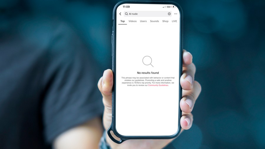 A hand holding a phone showing that no results can be found in a search on TikTok with the subject of AI nude