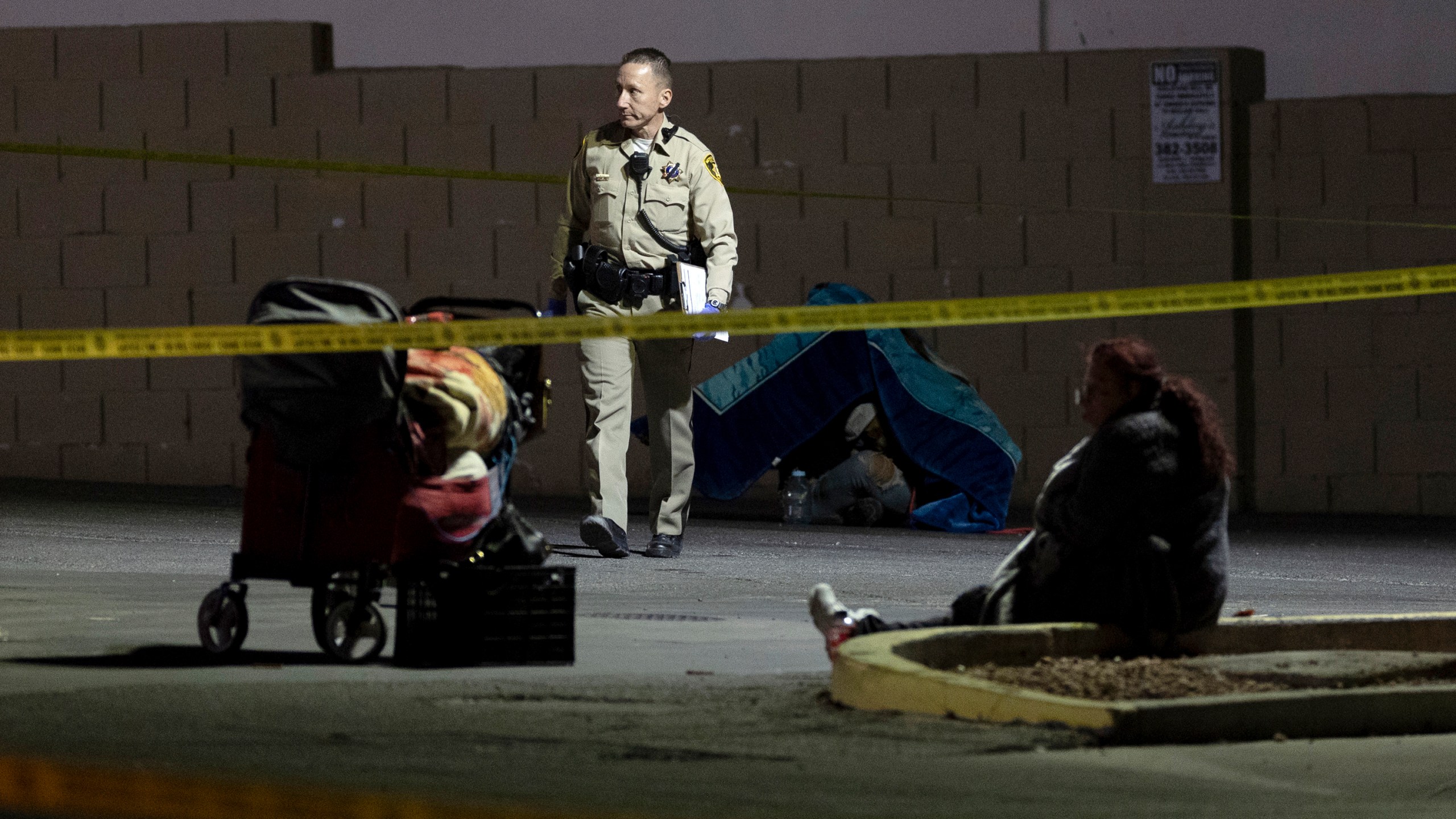 Metropolitan police investigate the scene of a shooting on Friday, Dec. 1, 2023, in Las Vegas. Five homeless people were shot, Friday, one of them fatally, and police were searching for a lone suspect, authorities said. (Ellen Schmidt /Las Vegas Review-Journal via AP)