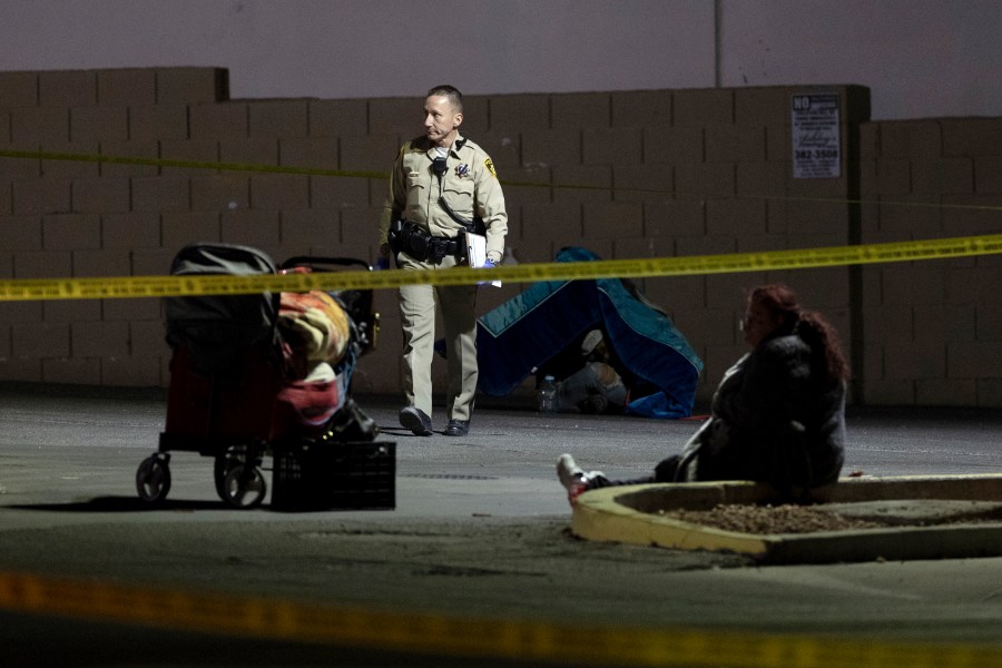 Metropolitan police investigate the scene of a shooting on Friday, Dec. 1, 2023, in Las Vegas. Five homeless people were shot, Friday, one of them fatally, and police were searching for a lone suspect, authorities said. (Ellen Schmidt /Las Vegas Review-Journal via AP)