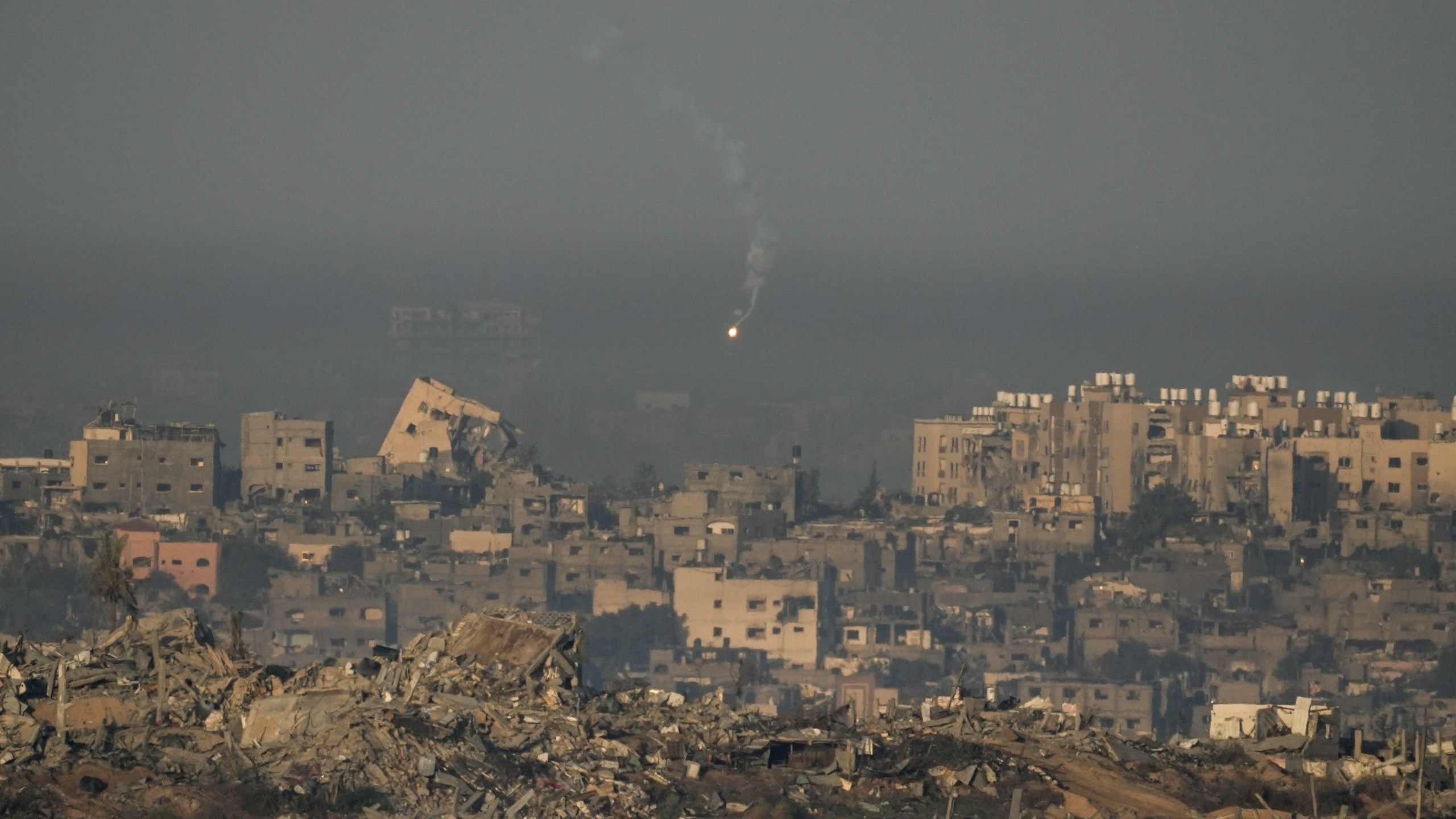 An Israeli army flare is seen over the Gaza Strip, as seen from southern Israel, Sunday, Dec. 3, 2023. (AP Photo/Leo Correa)