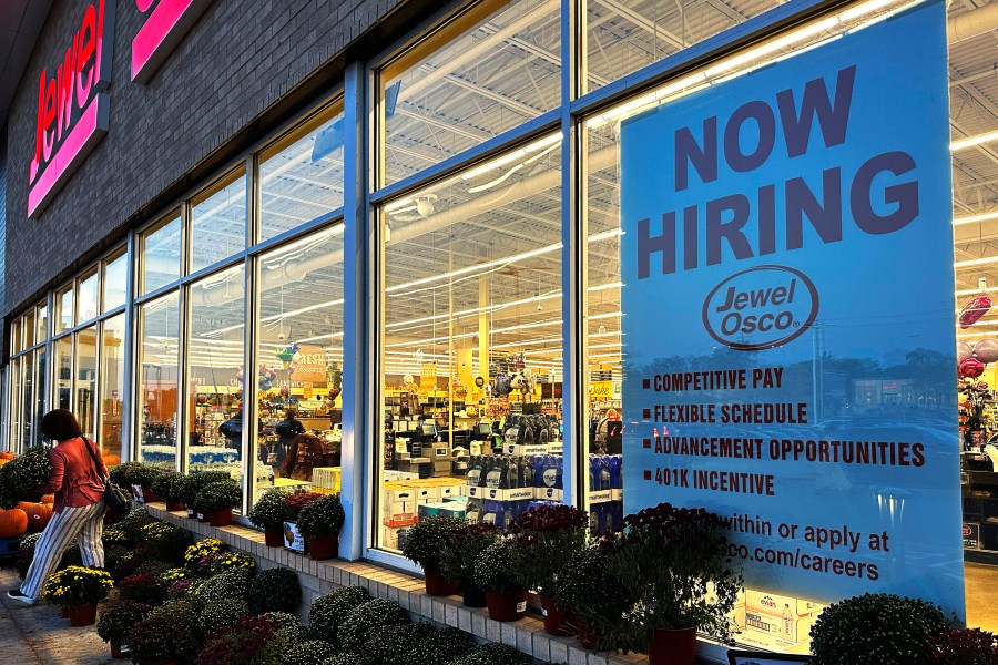 FILE - A hiring sign is displayed at a grocery store, Oct. 5, 2023, in Deerfield, Ill. Most business economists think the U.S. economy could avoid a recession in 2024, even if the job market ends up weakening under the weight of high interest rates, according to a survey released Monday, Dec. 4. (AP Photo/Nam Y. Huh, File)