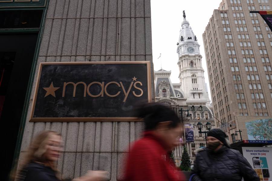 People walk past a closed Macy's retail location after reports of an alleged stabbing at the department store, Monday, Dec. 4, 2023, in view of City Hall in Philadelphia. Philadelphia police say a man stabbed two security guards, killing one and injuring the other. (AP Photo/Matt Rourke)