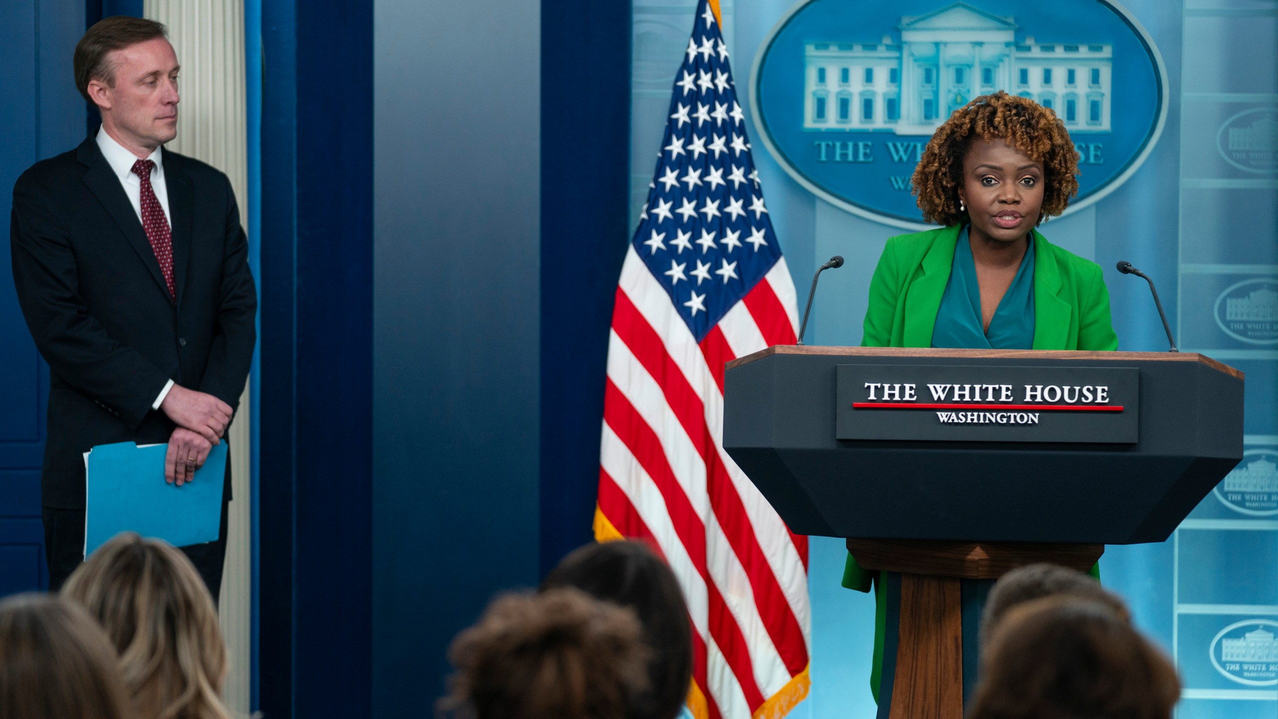 White House national security adviser Jake Sullivan listens as White House press secretary Karine Jean-Pierre speaks during a press briefing at the White House, Monday, Dec. 4, 2023, in Washington. (AP Photo/Evan Vucci)