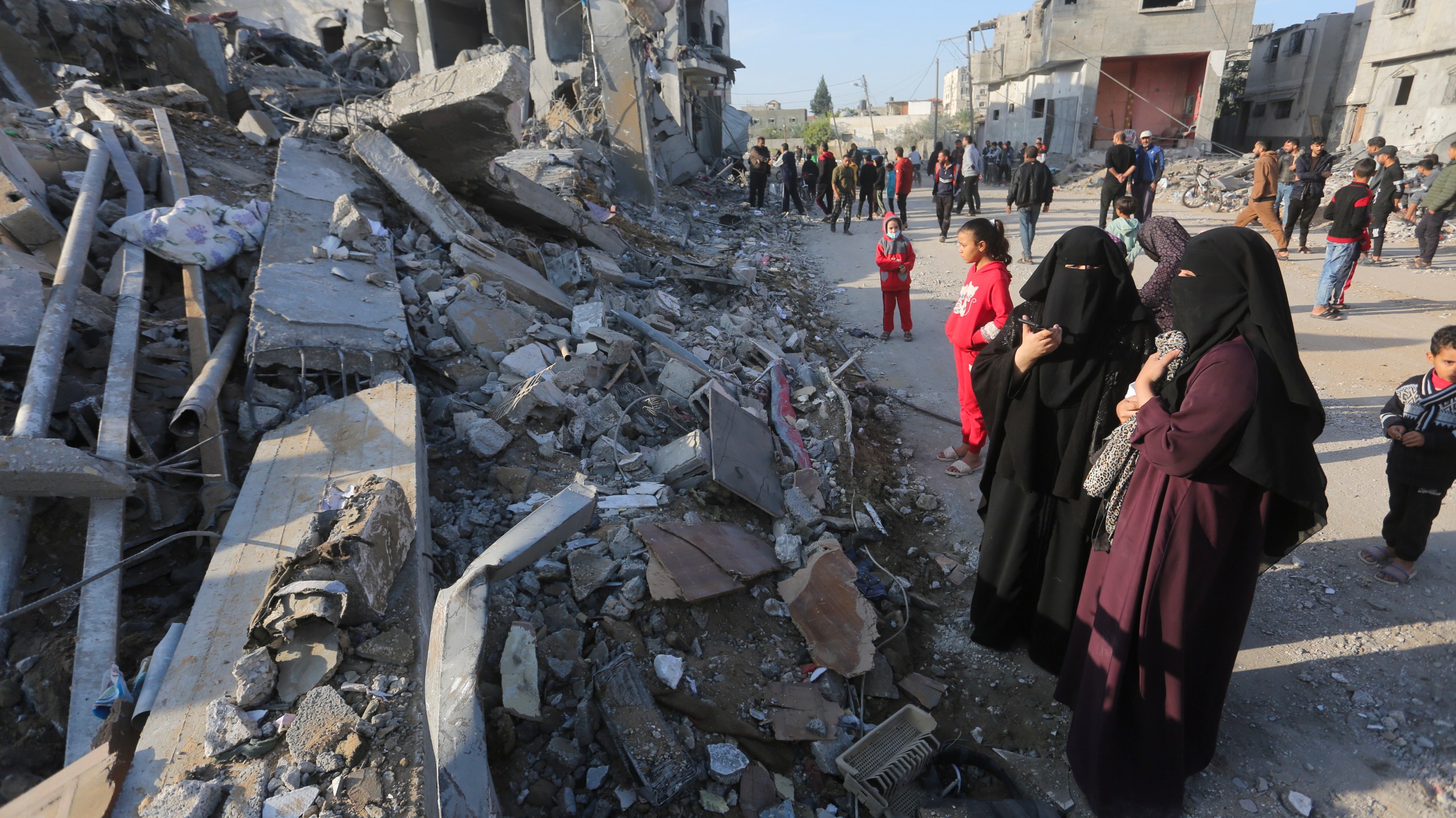 Palestinians look at the destruction by the Israeli bombardment of the Gaza Strip in Rafah, Monday, Dec. 4, 2023. (AP Photo/Hatem Ali)