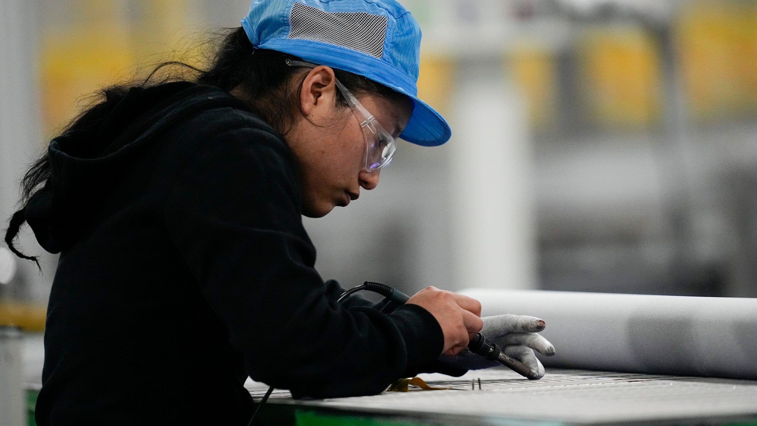 File - An employee works inside the Hanwha Qcells Solar plant on Oct. 16, 2023, in Dalton, Ga. On Tuesday, the Labor Department reports on job openings and labor turnover for October. (AP Photo/Mike Stewart, File)