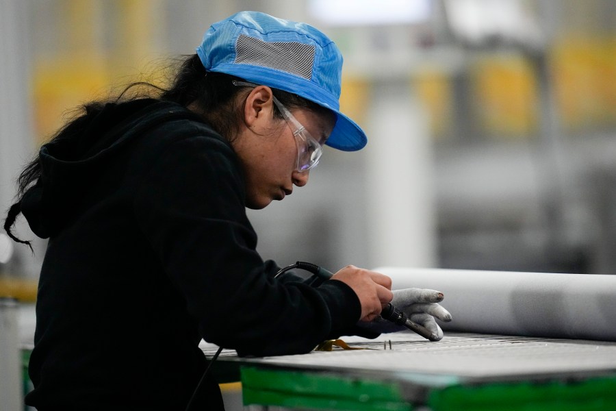 File - An employee works inside the Hanwha Qcells Solar plant on Oct. 16, 2023, in Dalton, Ga. On Tuesday, the Labor Department reports on job openings and labor turnover for October. (AP Photo/Mike Stewart, File)